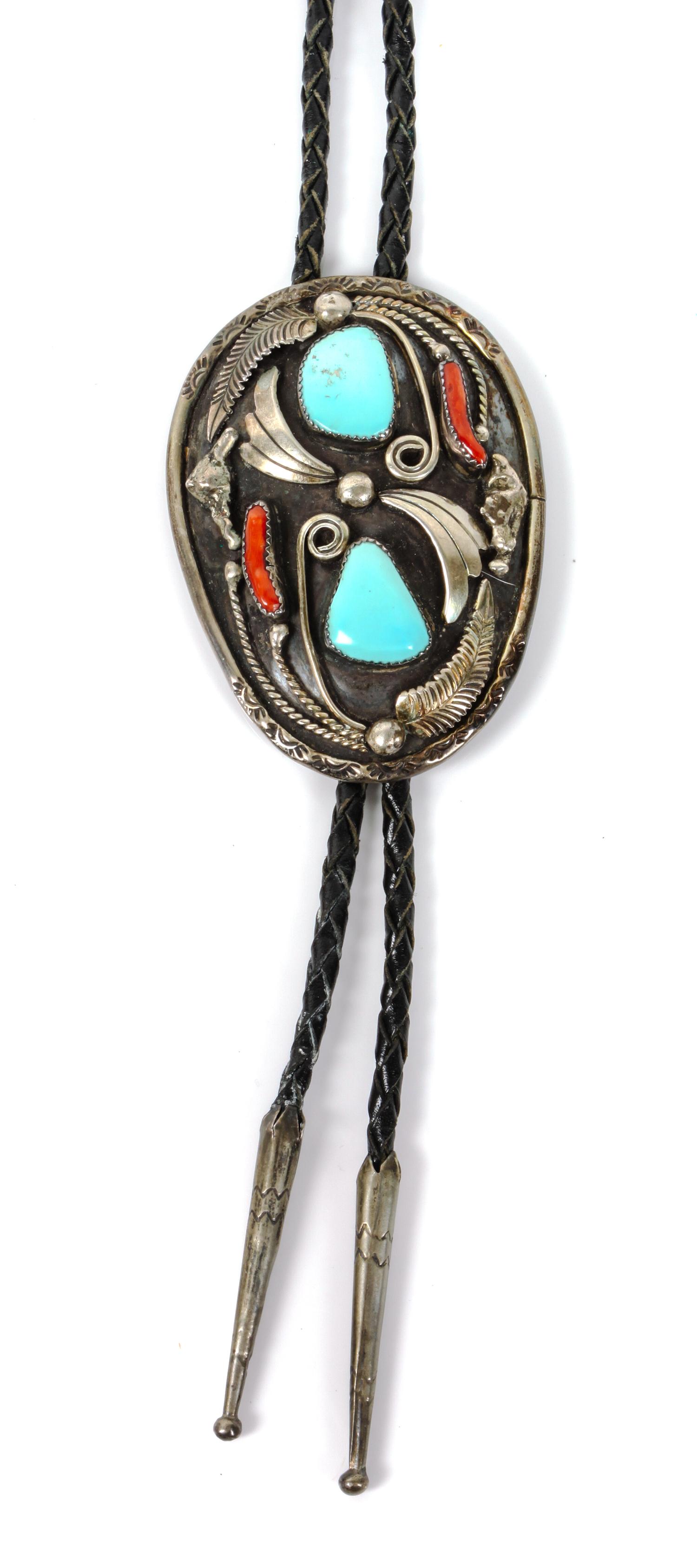 A Southwestern Silver, Turquoise and Coral Bolo Height 3 x 2 1/4 inches.