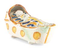 A Staffordshire Pearlware Figure of a Child in a Cradle