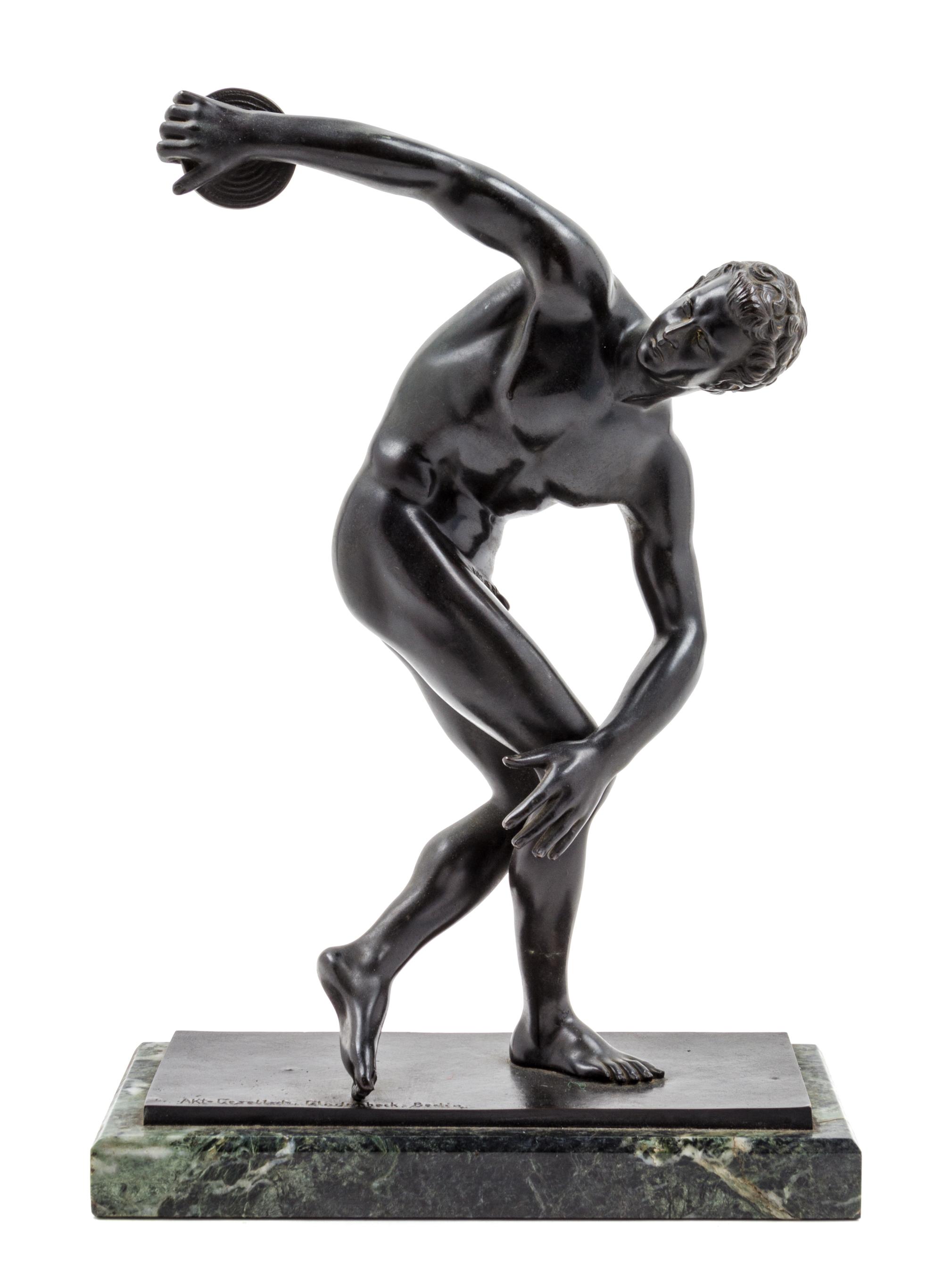 A German Bronze Figure of a Discus Thrower Height overall 14 1/2 inches. — AFTER THE ANTIQUE, CAST BY AKTIEN GESELLSCHAFT GLADENBECK, BERLIN