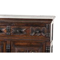 A Flemish Paneled and Molded Oak Chest of Drawers