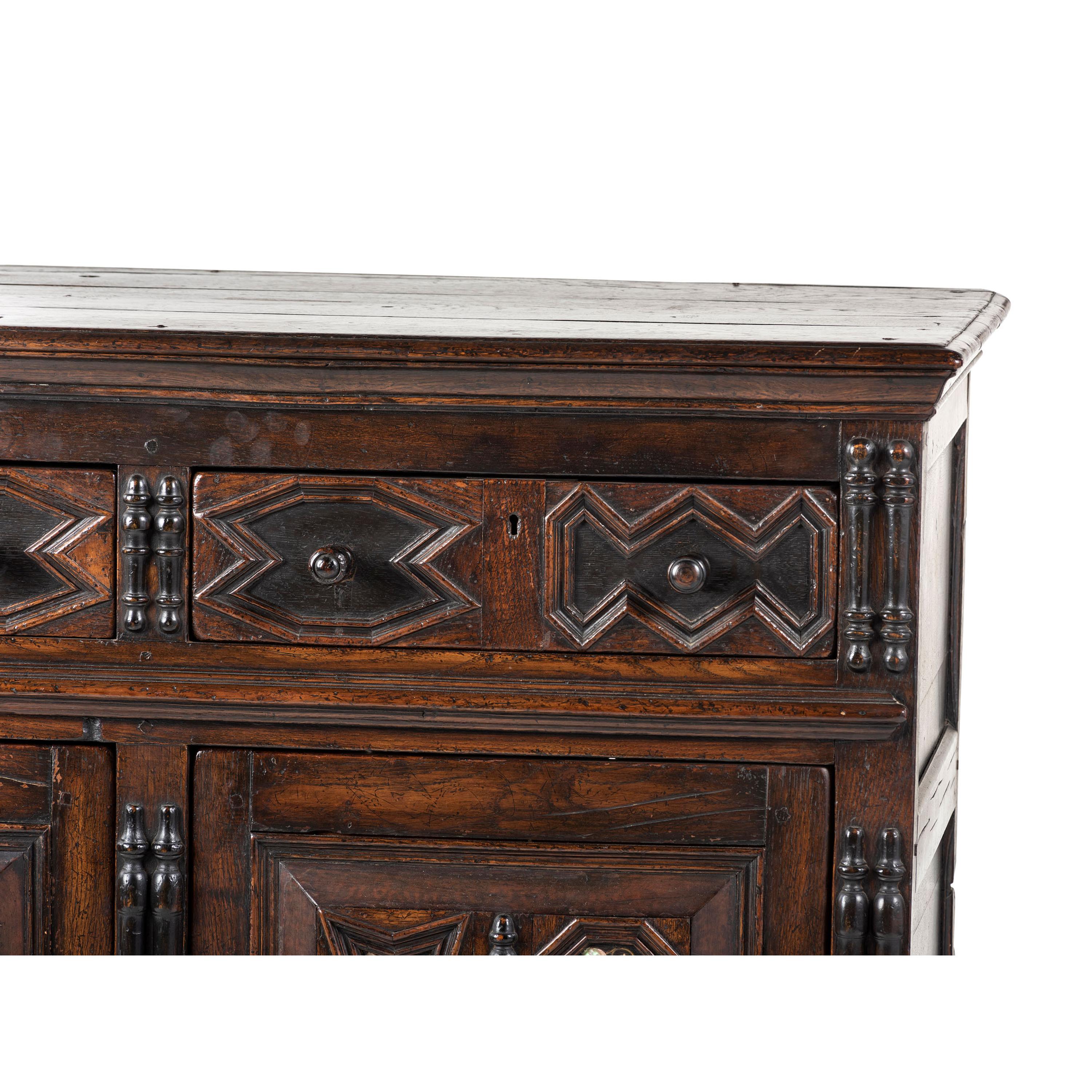 A Flemish Paneled and Molded Oak Chest of Drawers
