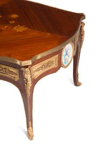 A Louis XV Style Gilt Bronze and Porcelain Mounted Low Table