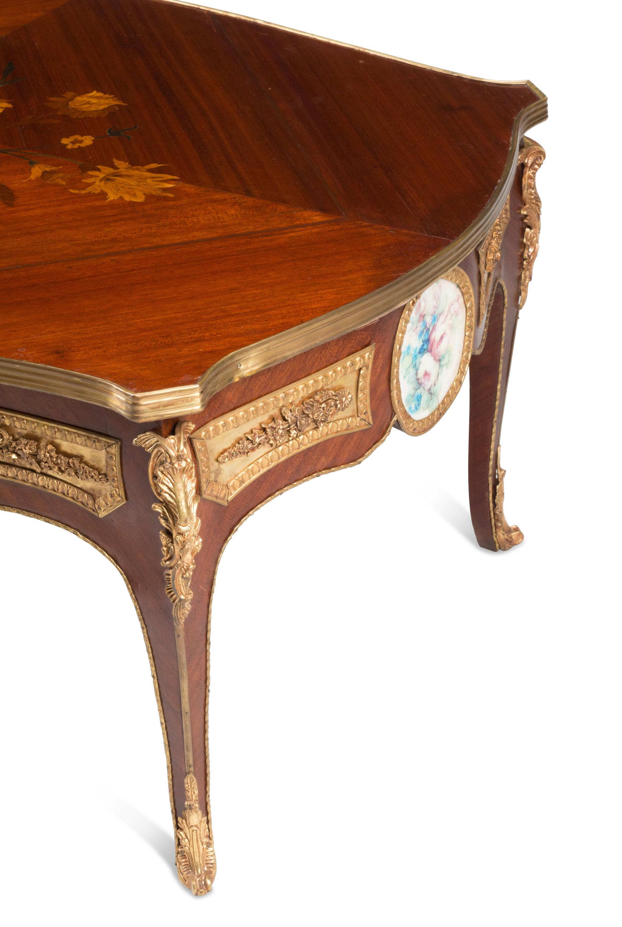 A Louis XV Style Gilt Bronze and Porcelain Mounted Low Table