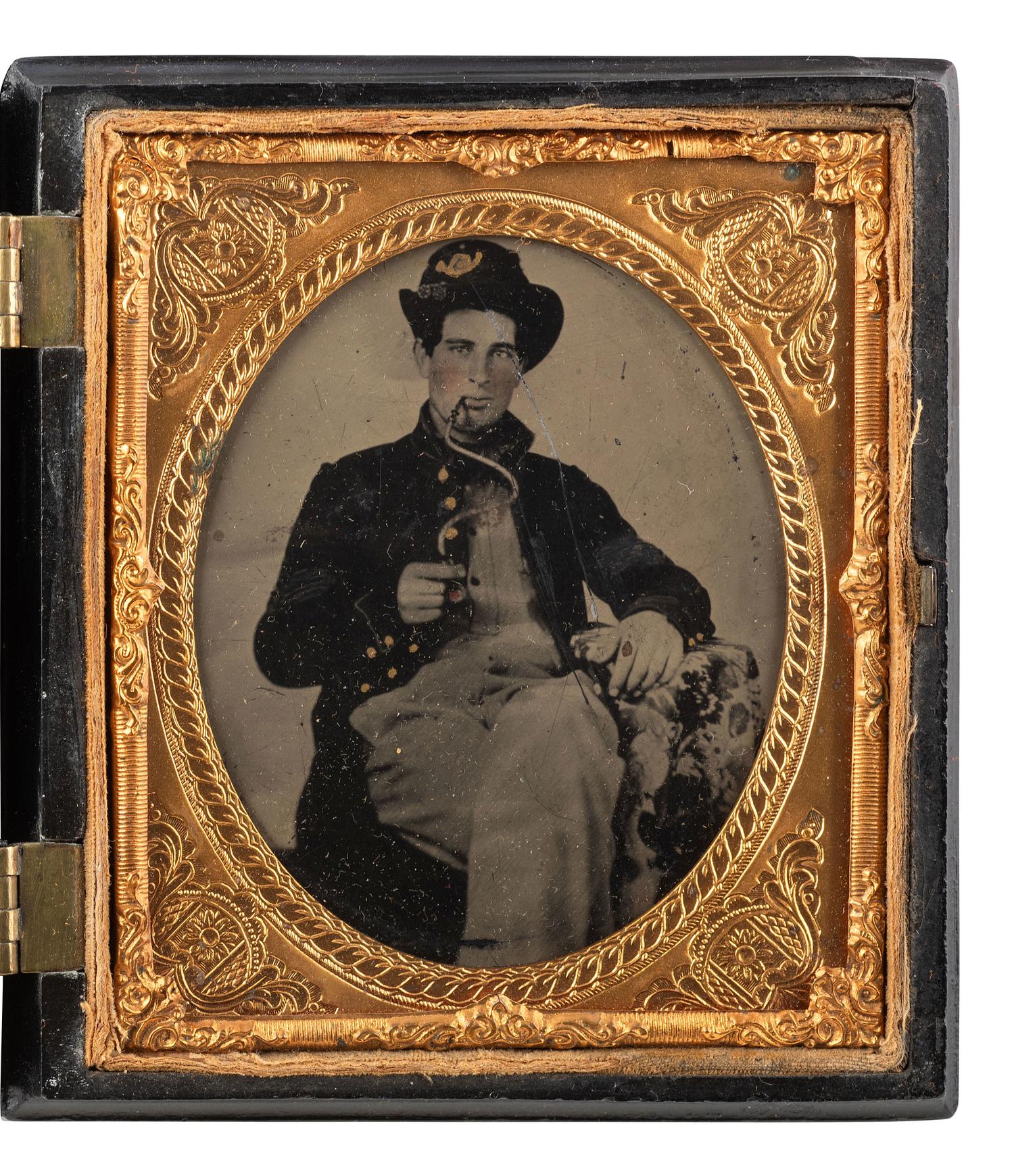 [CIVIL WAR]. Sixth plate tintype of a Union soldier, likely western theater, smoking with a unique smoking apparatus.