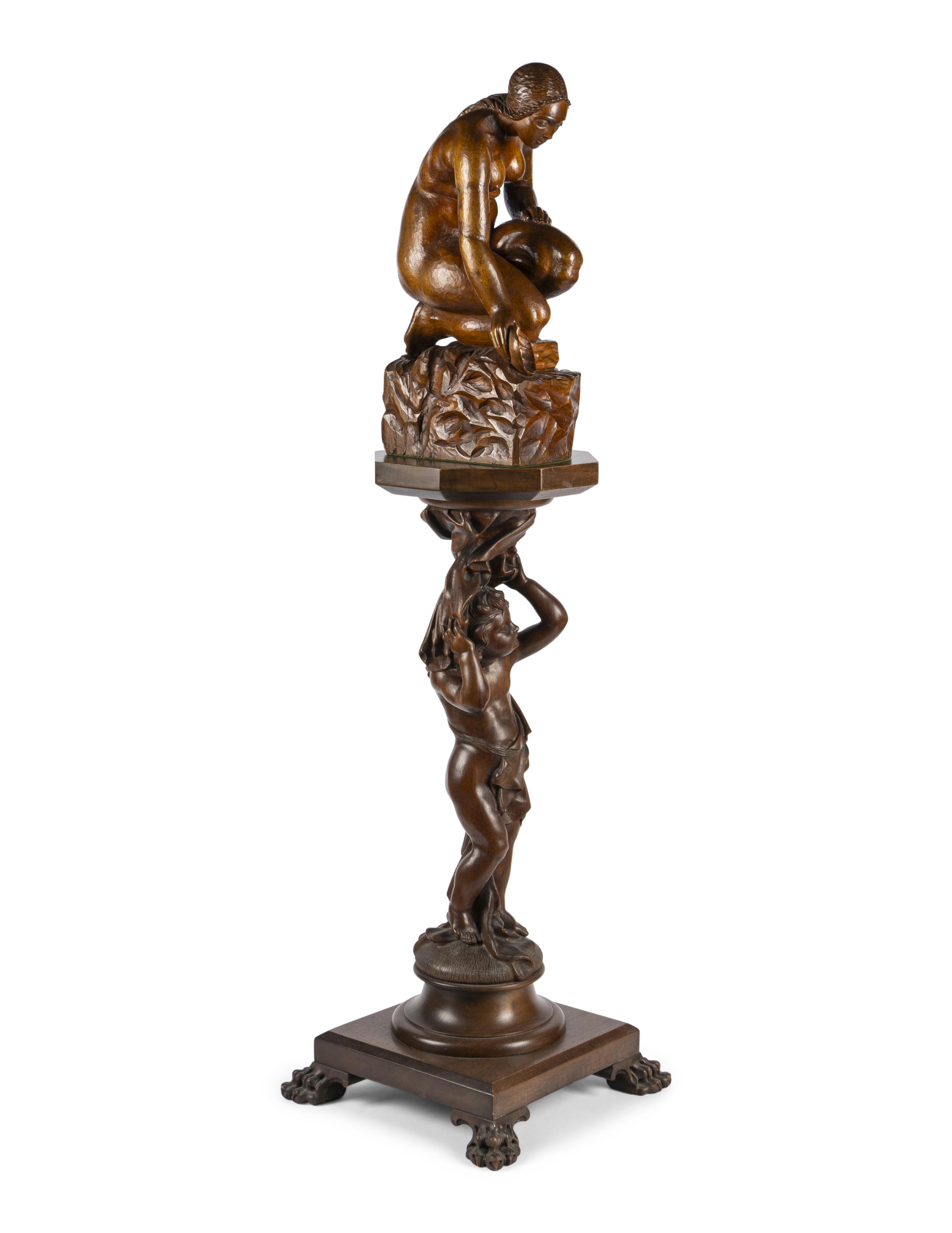 A Carved Wood Sculpture and a Venetian Style Carved Walnut Pedestal