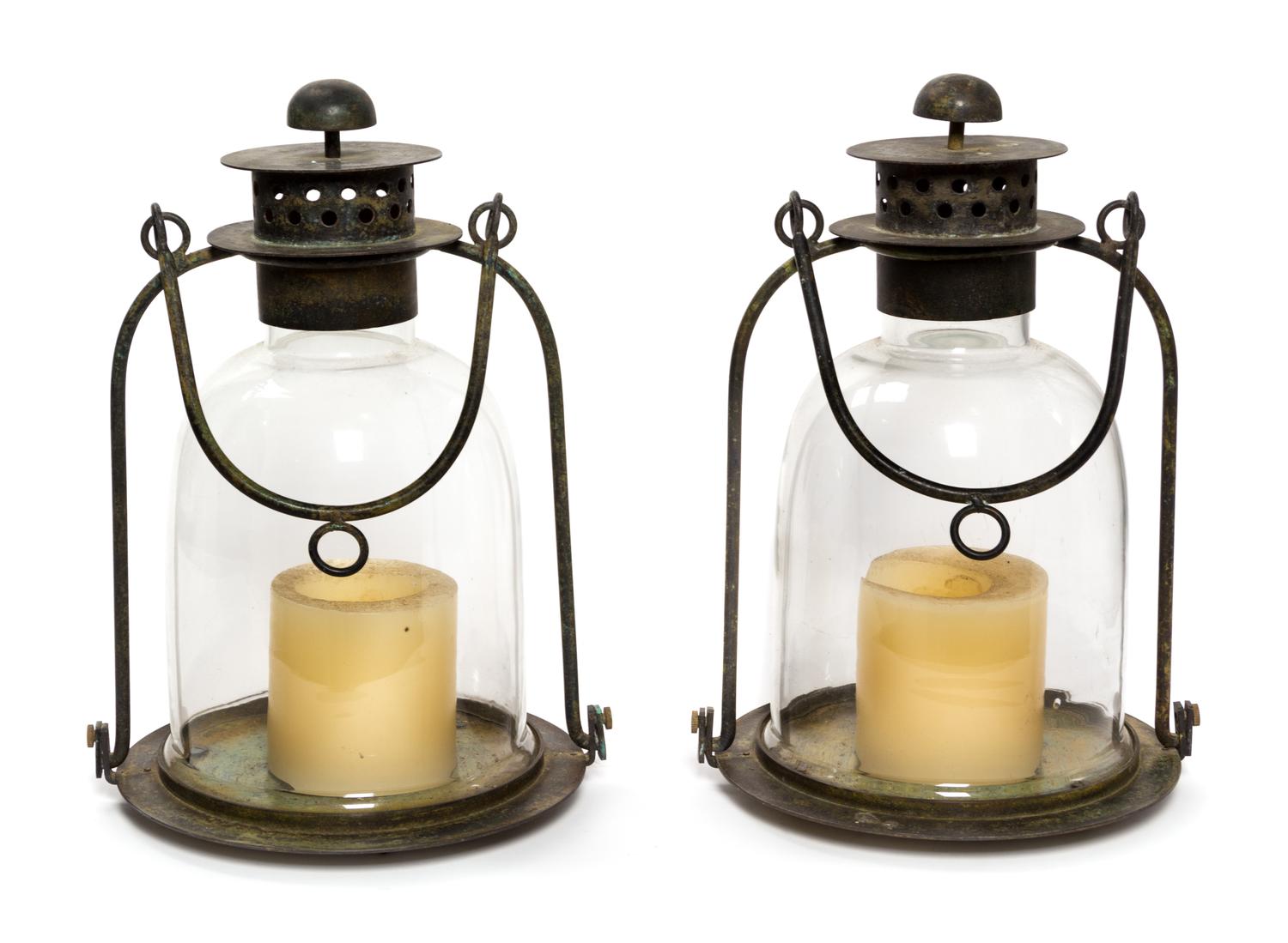 A Pair of Metal and Glass Lanterns Height 15 3/4 inches.