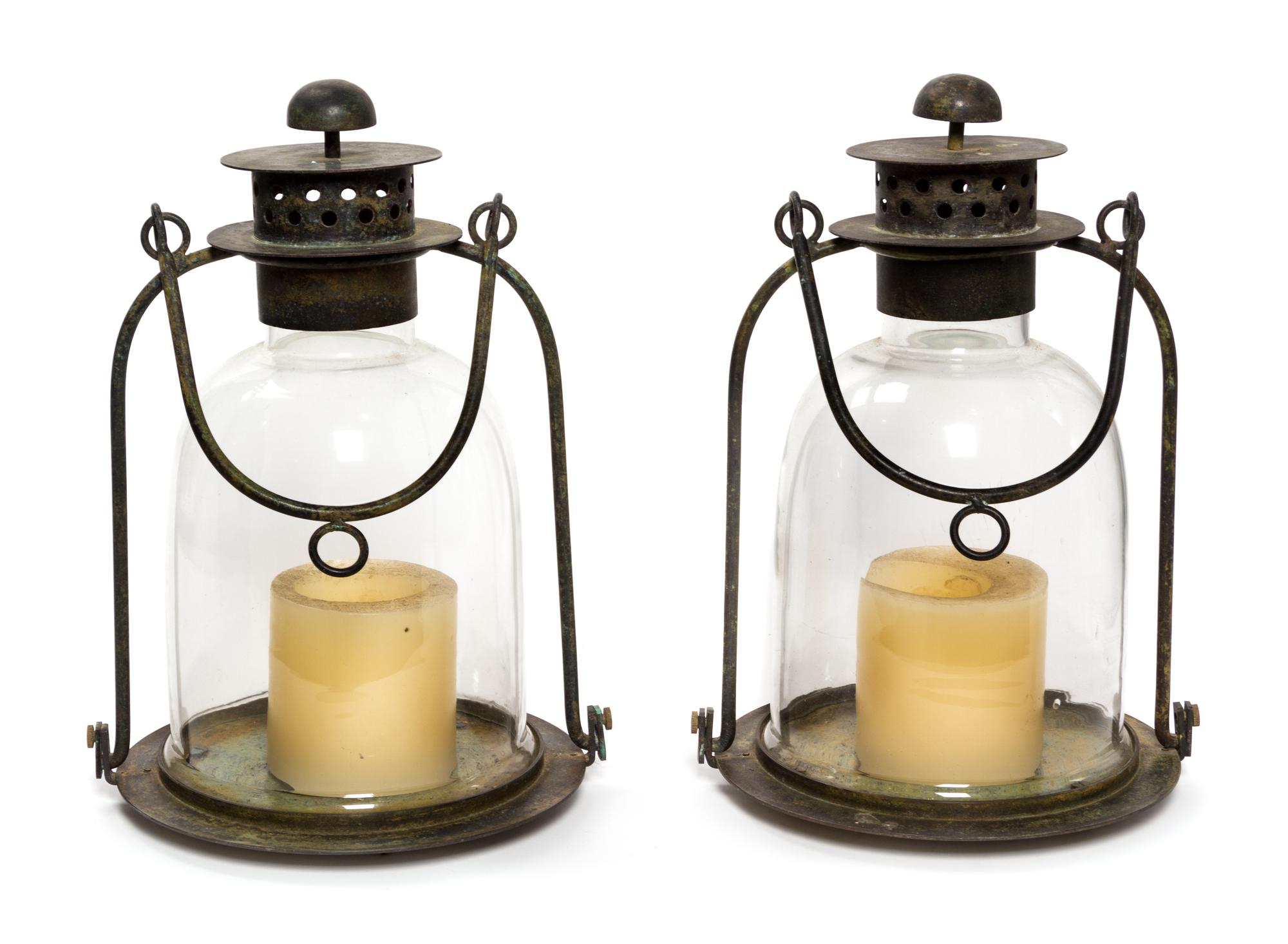 A Pair of Metal and Glass Lanterns Height 15 3/4 inches.