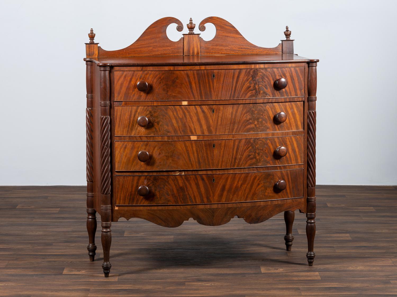 A Late Federal Spiral-Twist Carved and Figured Mahogany Chest of Drawers