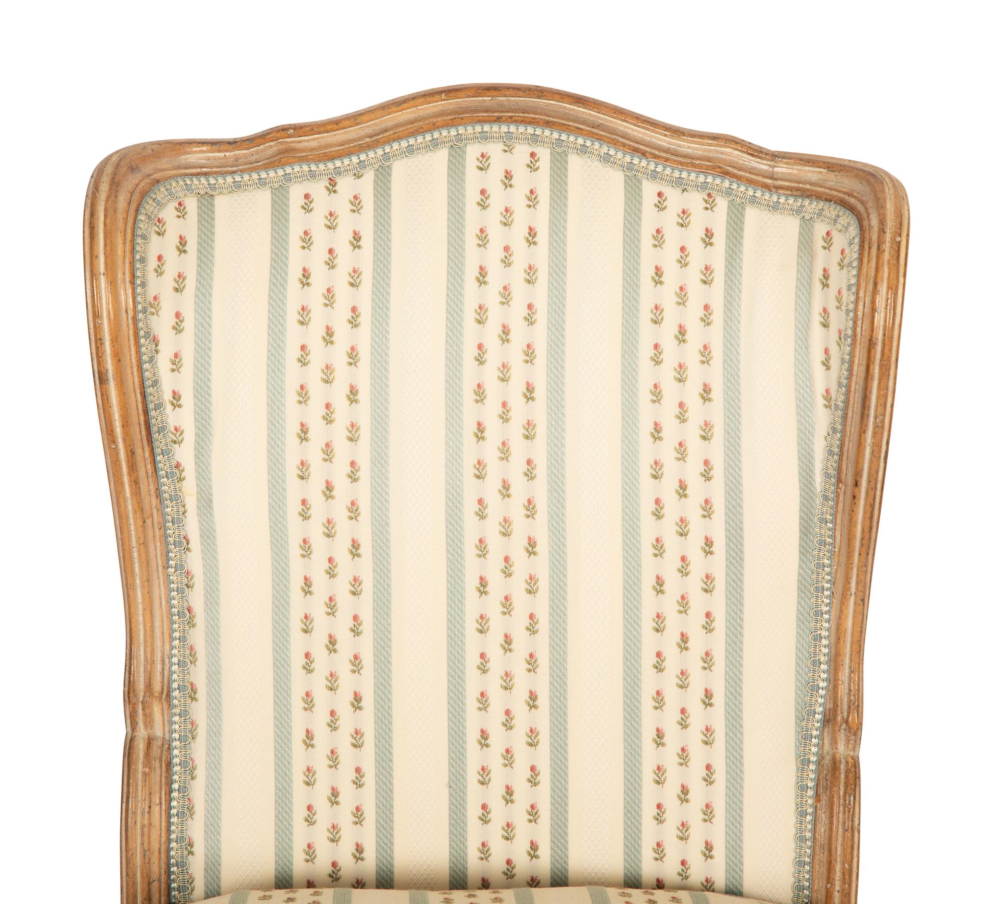 A Pair of Louis XV Style Carved Fruitwood Slipper Chairs