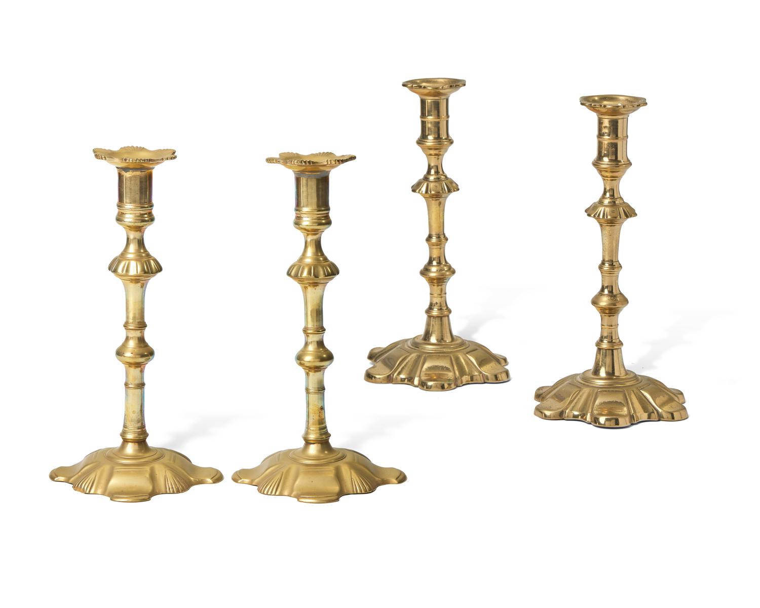 A Group of Four George III Brass Candlesticks