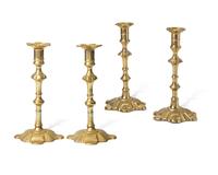 A Group of Four George III Brass Candlesticks