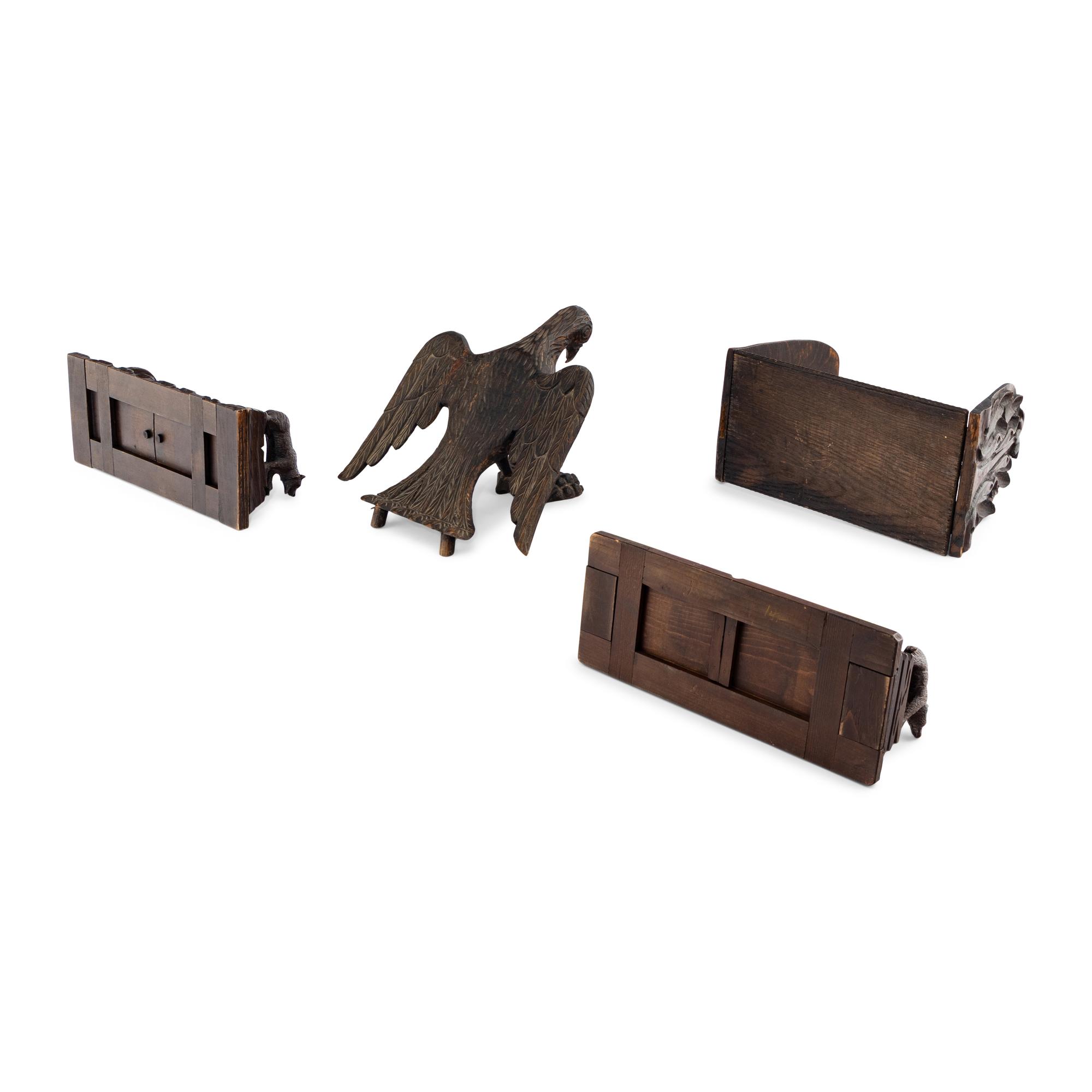 A Group of Four Black Forest Carved Book Racks and Stands