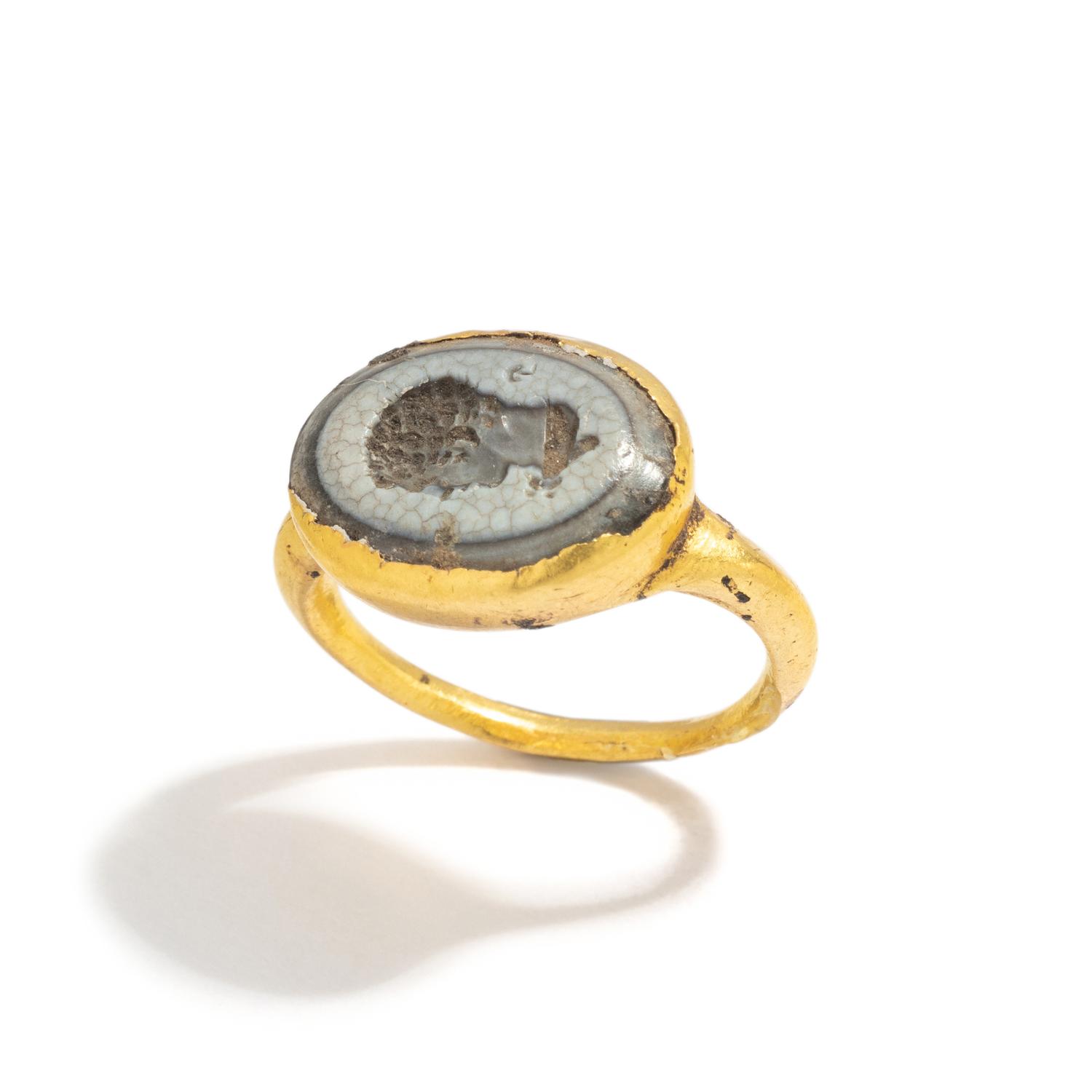 A Roman Gold and White Glass Finger Ring with a Male Portrait Head (Possibly a Young Hercules)
