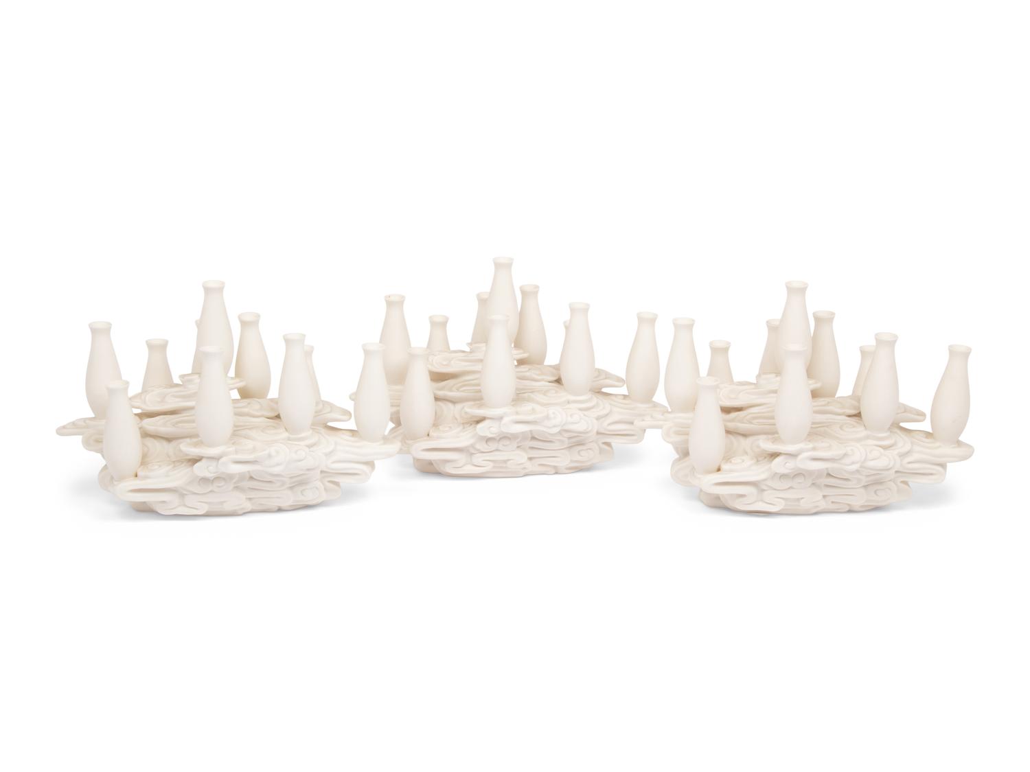 A Set of Three Contemporary Bisque Porcelain Candelabra