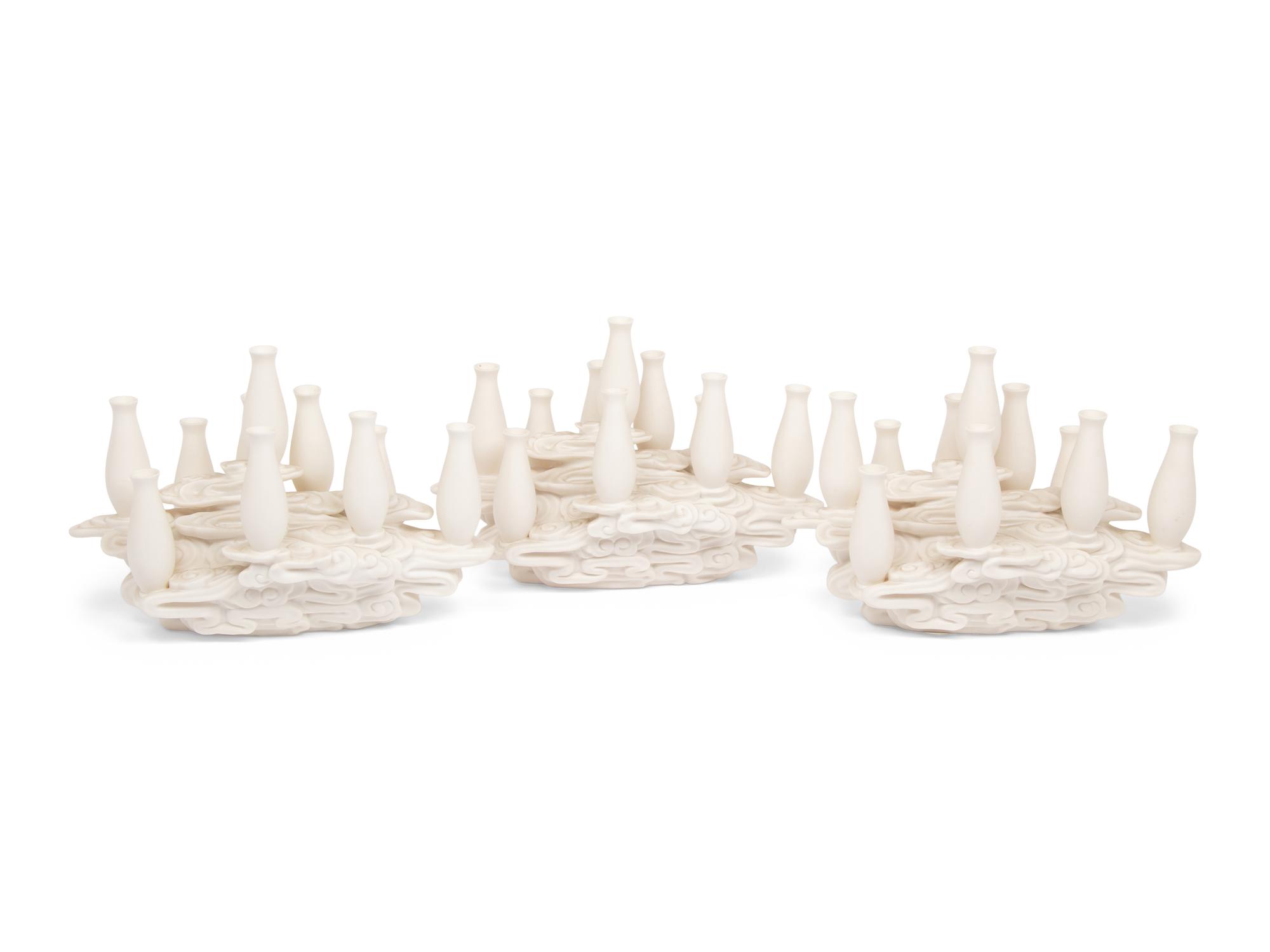 A Set of Three Contemporary Bisque Porcelain Candelabra