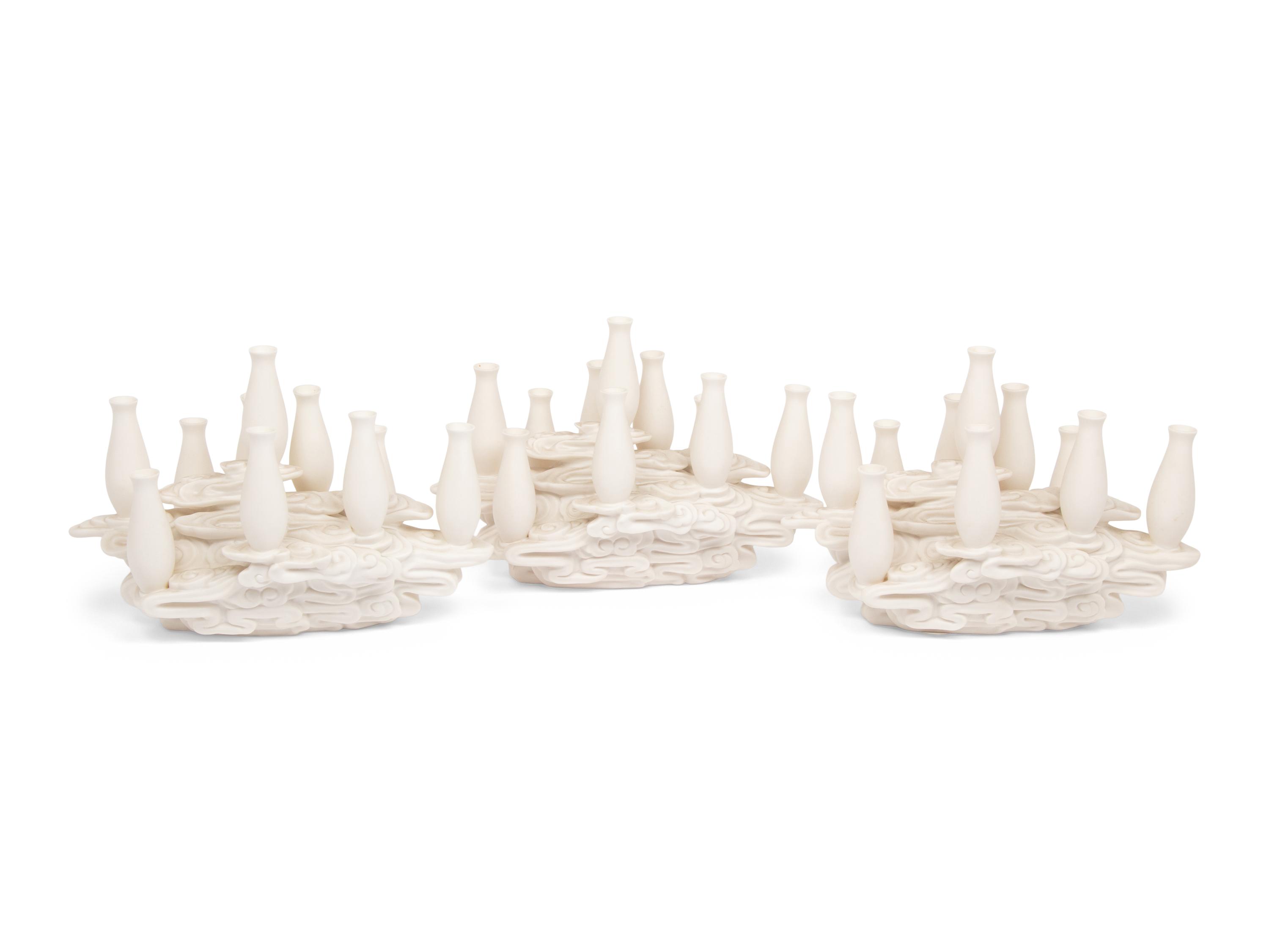 A Set of Three Contemporary Bisque Porcelain Candelabra