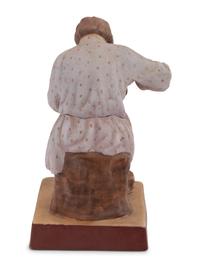 A Russian Porcelain Figure of a Bast Shoe Maker