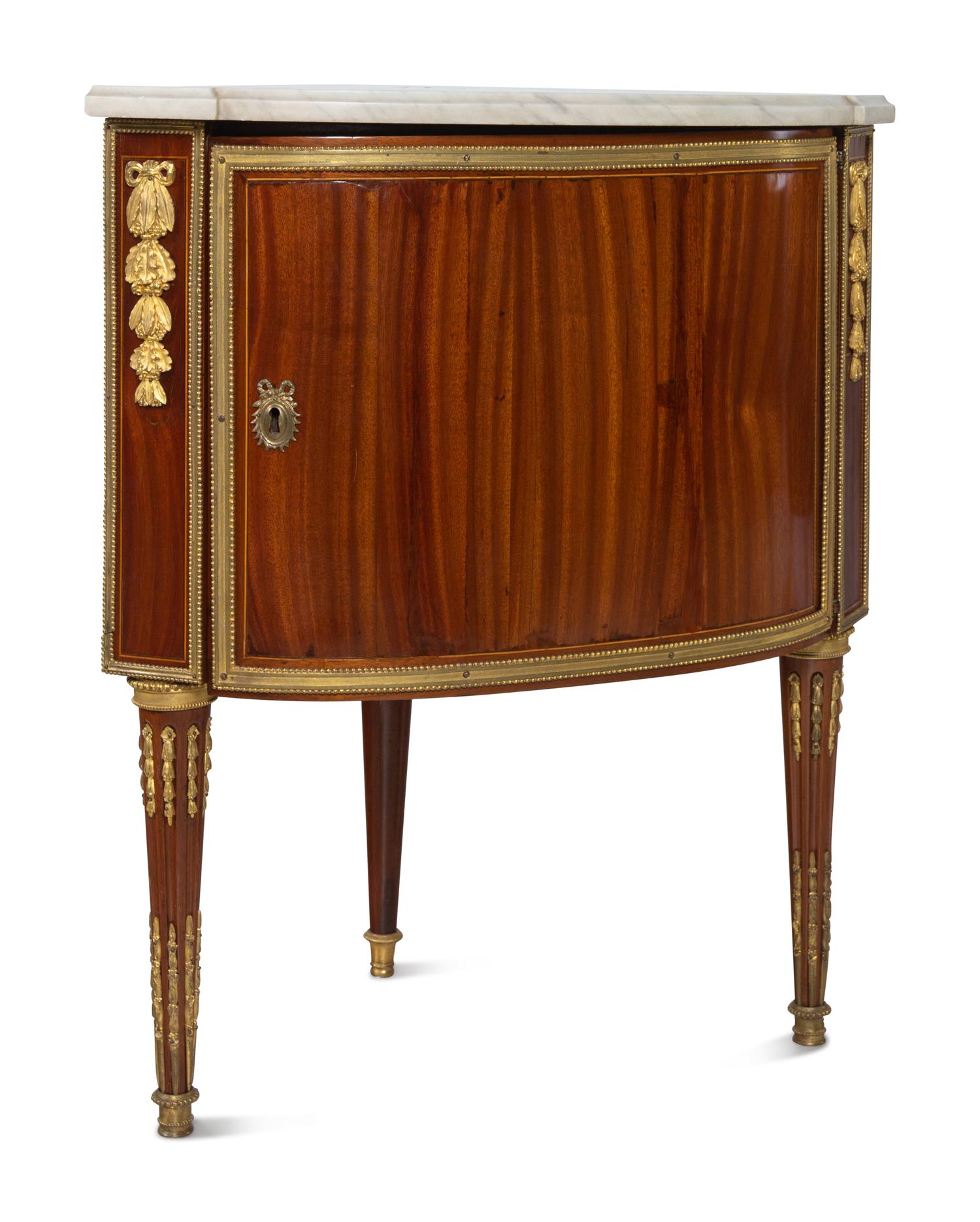 A Pair of Louis XVI Gilt Bronze Mounted Mahogany Marble-Top Encoignures by Charles Topino (French, 1742-1803)