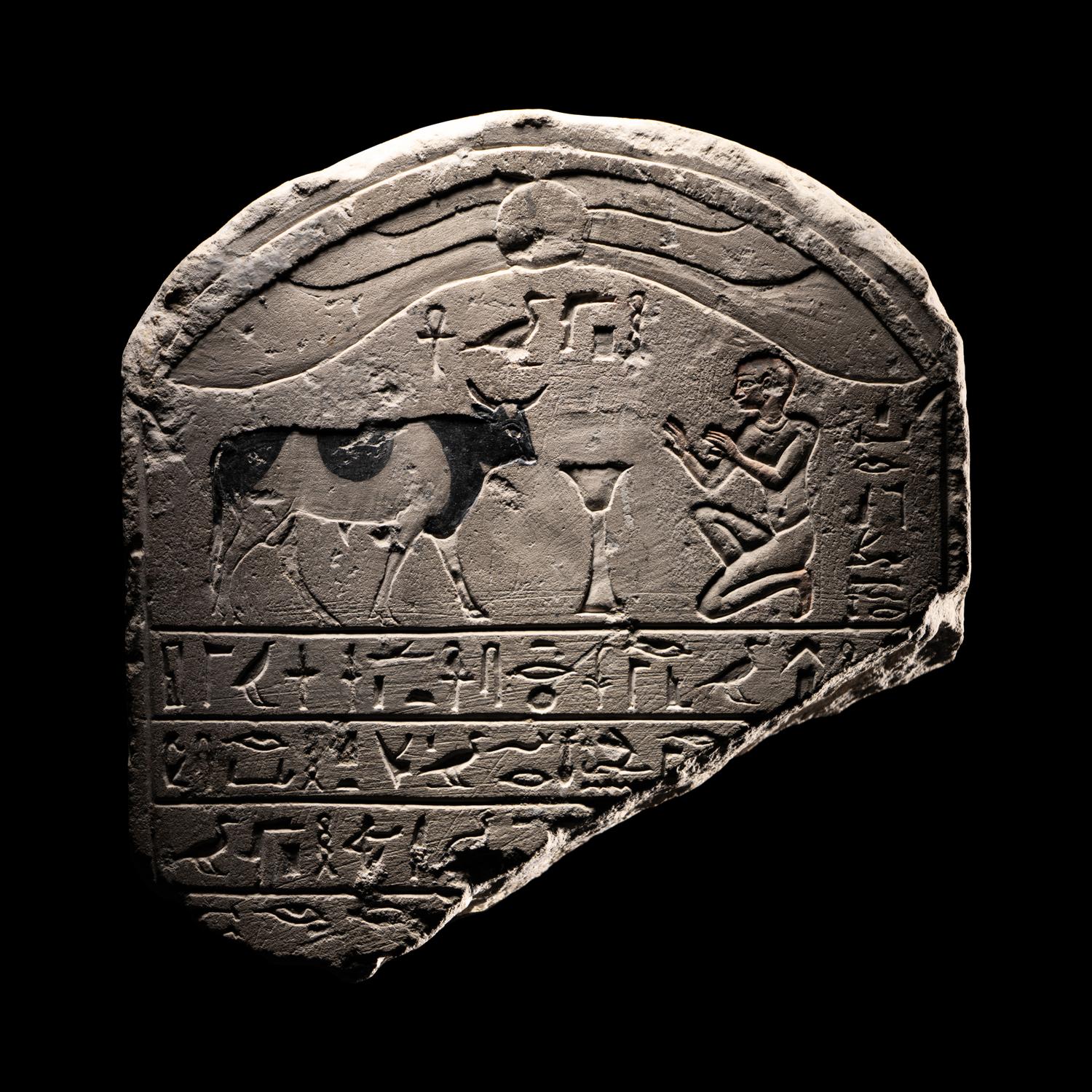 An Egyptian Limestone Round-Topped Stele