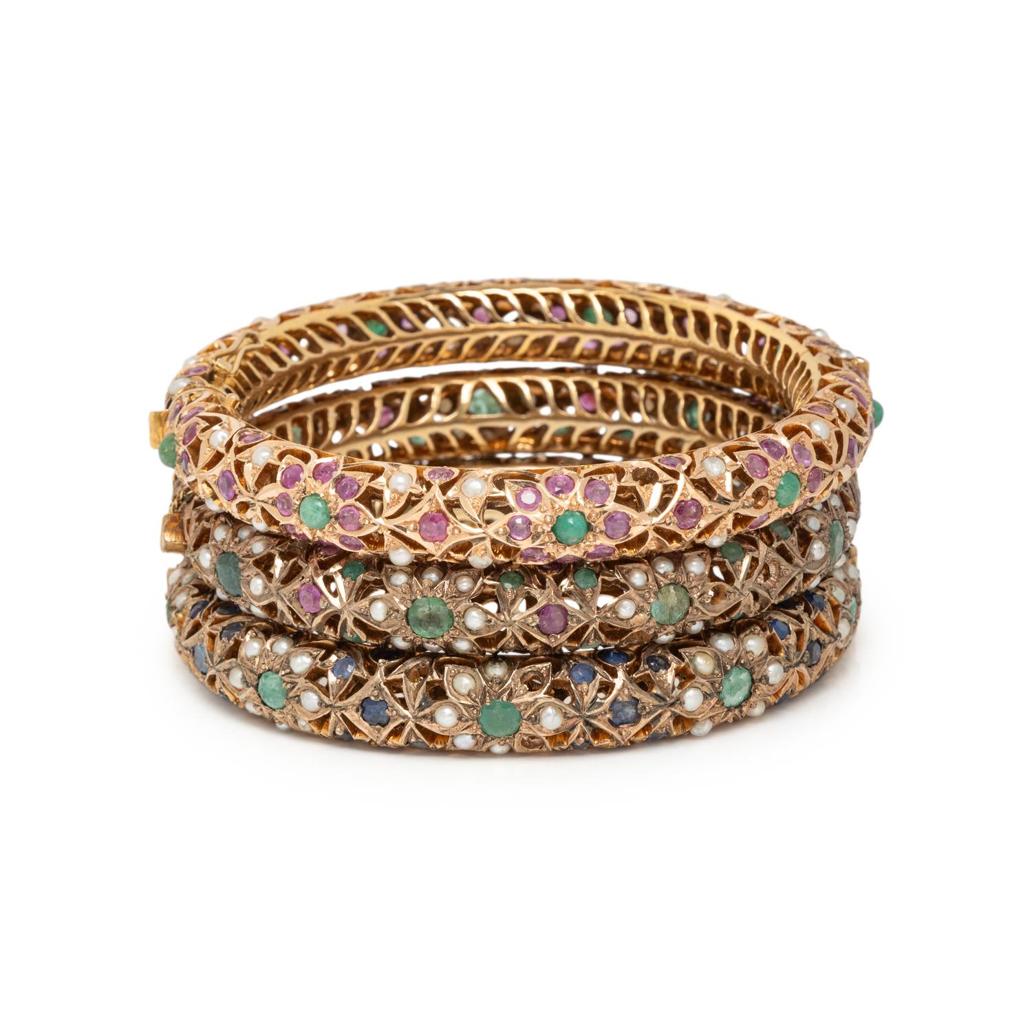 COLLECTION OF YELLOW GOLD AND LOW KARAT GOLD MULTIGEM BANGLE BRACELETS