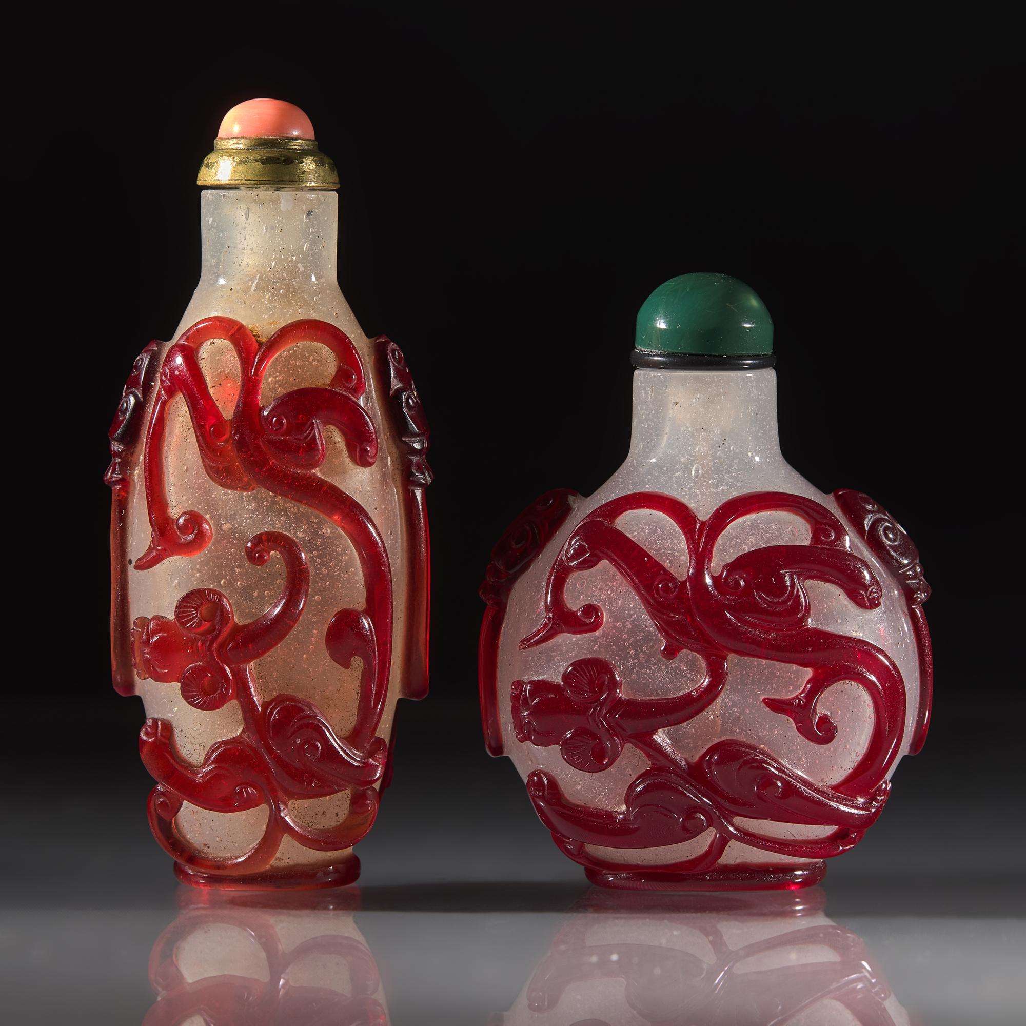 Two Chinese Carved Ruby Overlay Glass Snuff Bottles, Qing Dynasty, 18th/19th Century — 清中晚期 雪霏地套寶石紅料螭龍紋鼻煙壺兩支