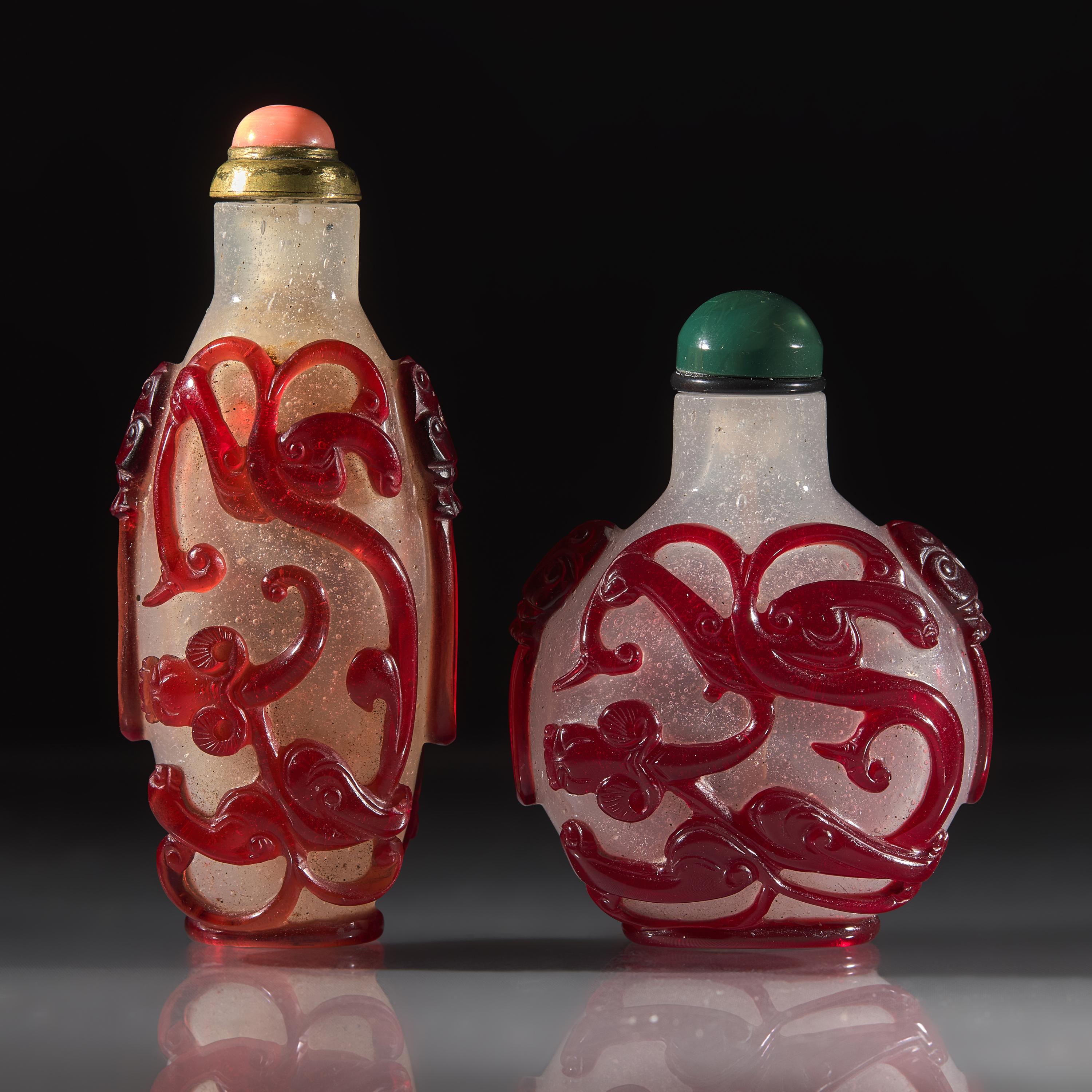 Two Chinese Carved Ruby Overlay Glass Snuff Bottles, Qing Dynasty, 18th/19th Century — 清中晚期 雪霏地套寶石紅料螭龍紋鼻煙壺兩支