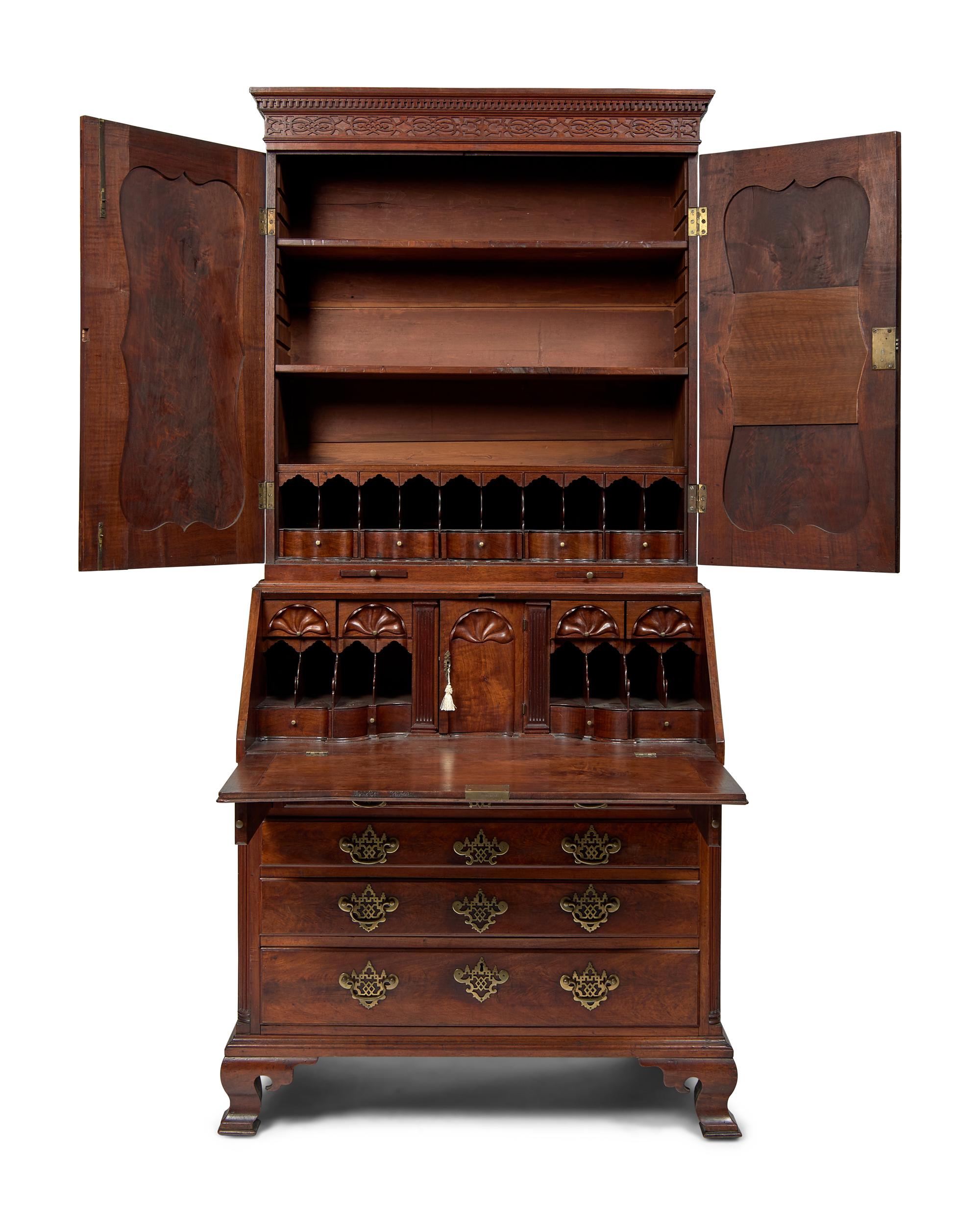 A Chippendale Figured and Carved Walnut Desk-and-Bookcase