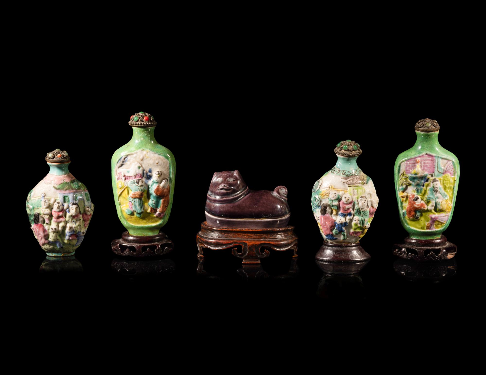 Four Chinese Famille Rose Porcelain Snuff Bottles and A Aubergine Glazed Porcelain Dog-Form Paper Weight