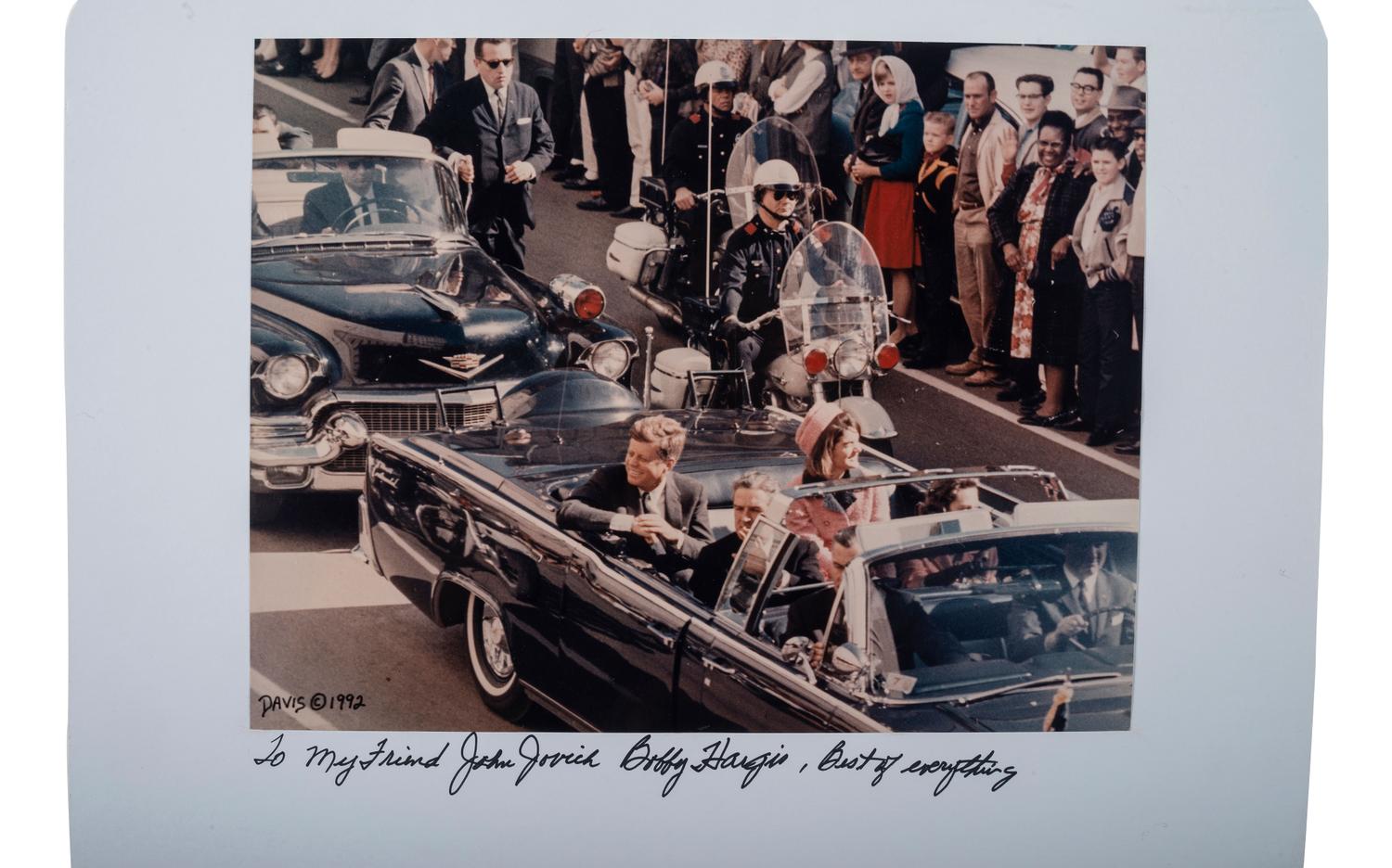 [POLITICS] -- [KENNEDY, John F. (1917-1963)]. Officer Bobby Hargis' Dallas Police shoulder patch worn during the Kennedy Assassination with inscribed photograph from Officer Hargis.