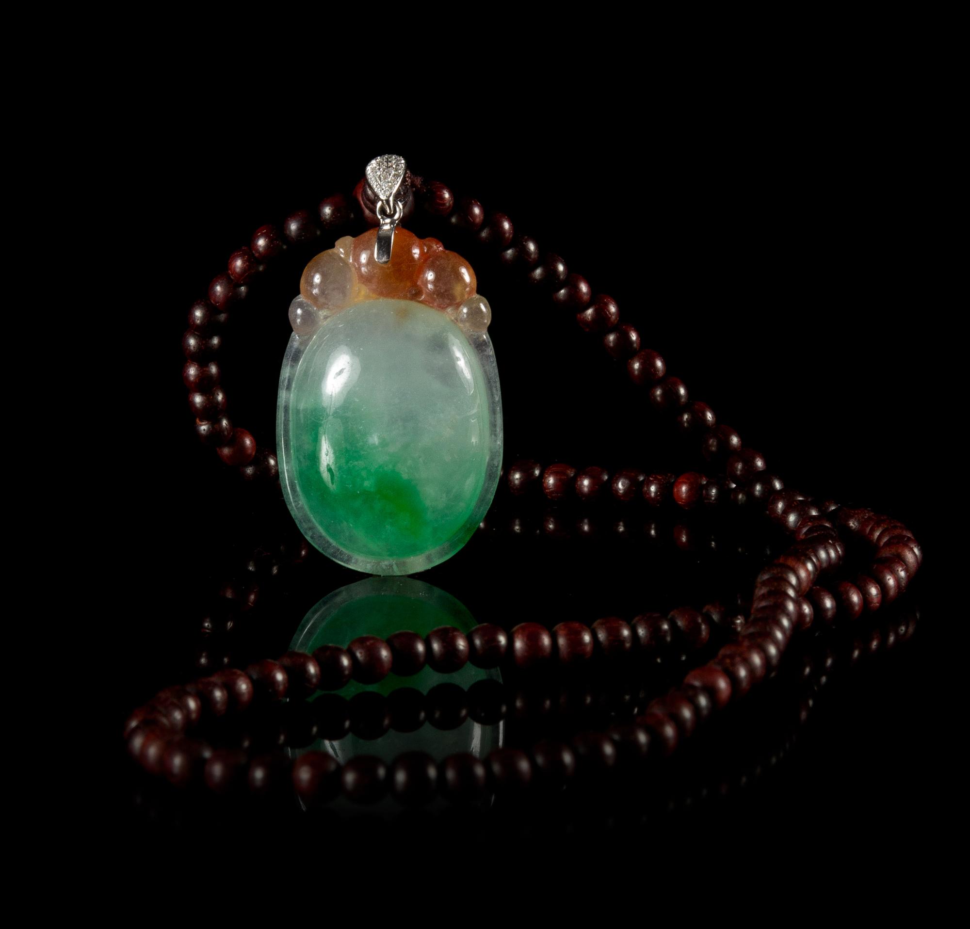 A Jadeite Pendant Length of pendant 1 3/4 inches.