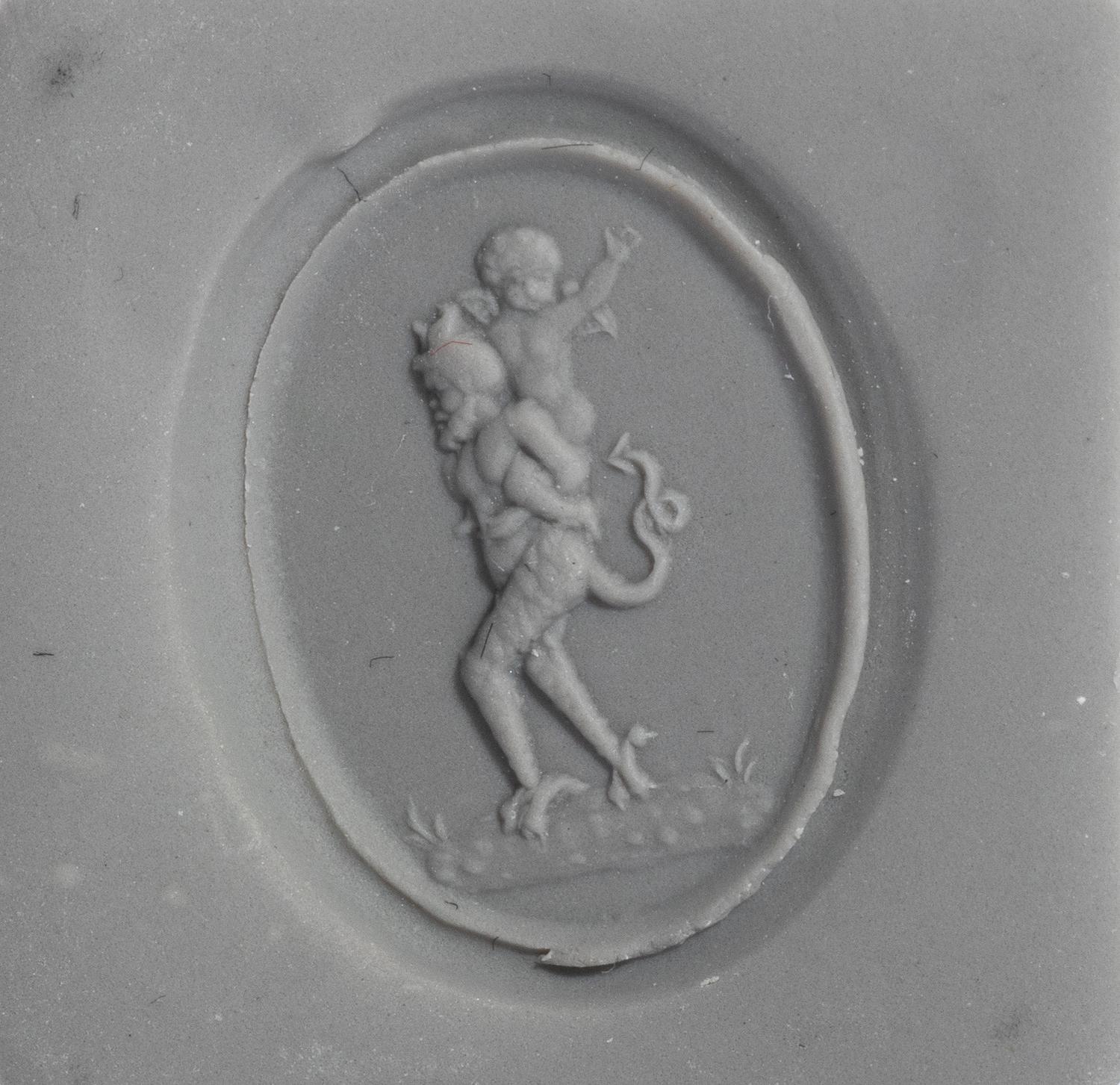 A Neoclassical Gold and Carnelian Finger Ring with the God Eros Riding a Satyr