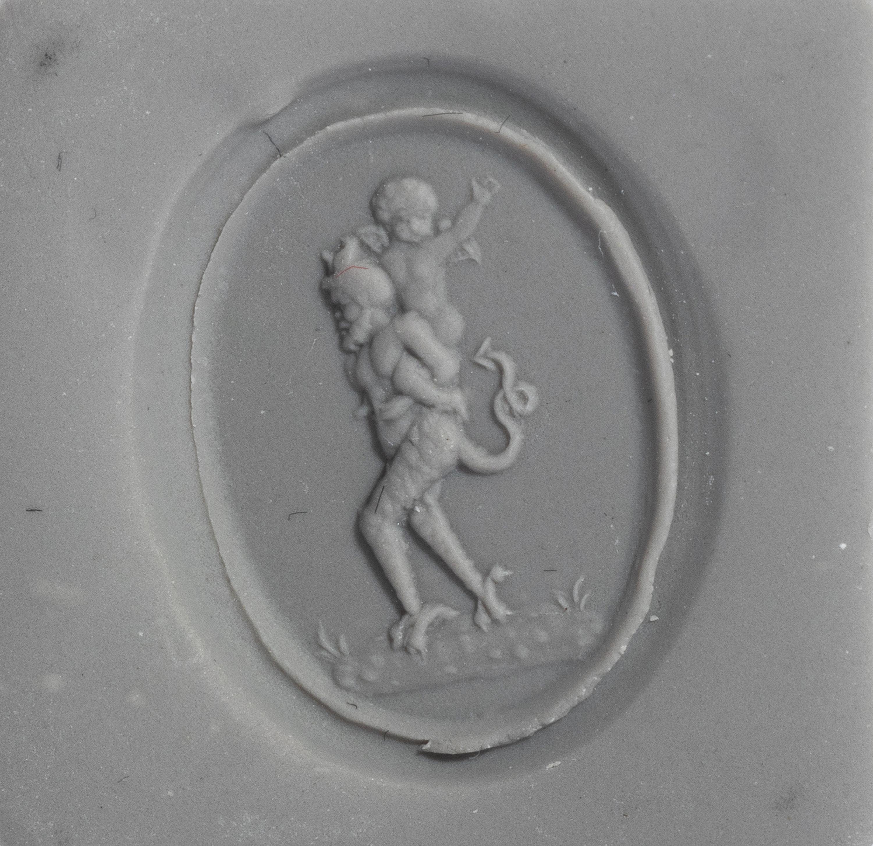A Neoclassical Gold and Carnelian Finger Ring with the God Eros Riding a Satyr
