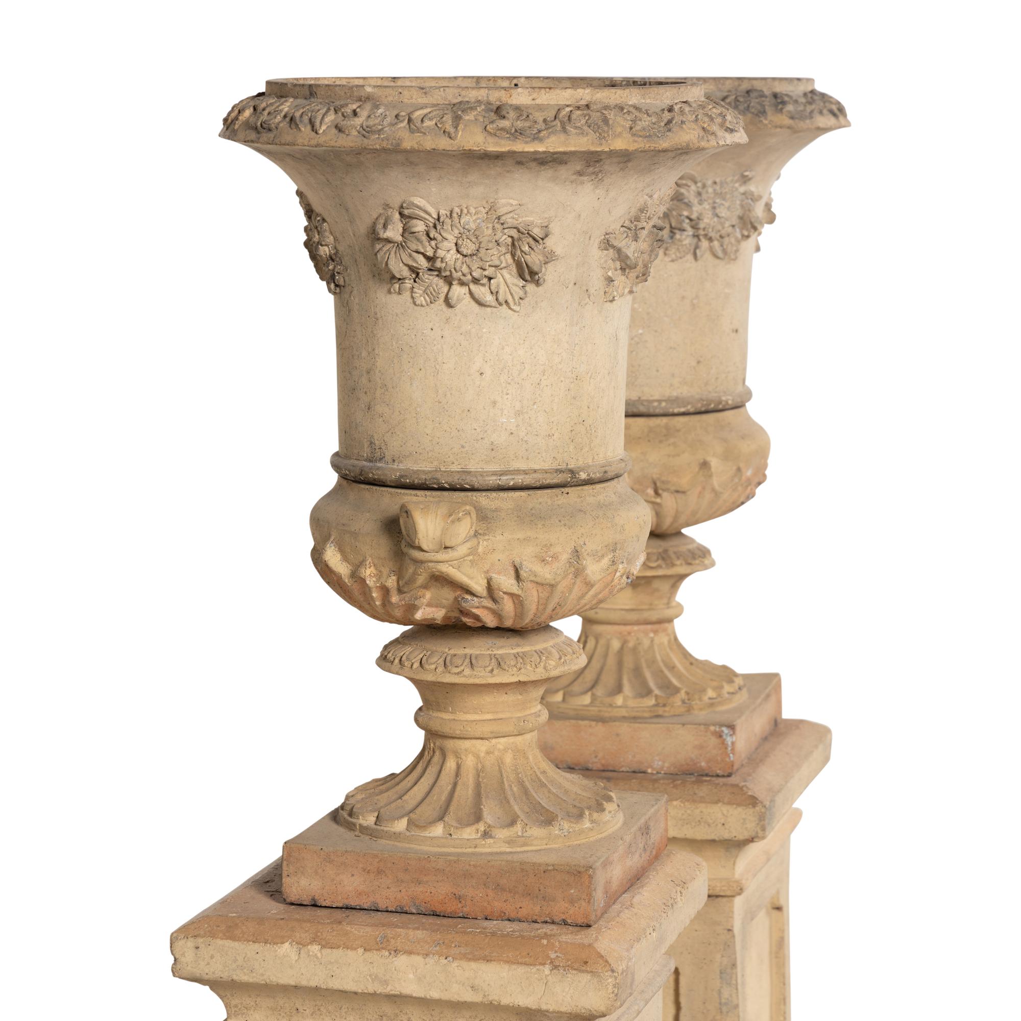 A Pair of Terra Cotta Garden Urns and Plinths