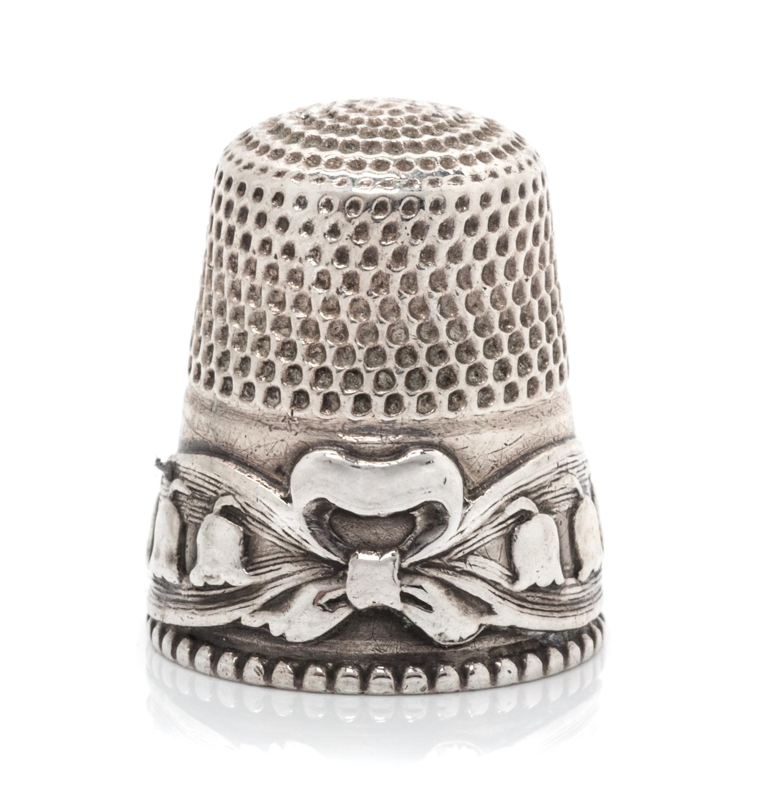 An American Silver Lily of the Valley Thimble, Stern Bros., Philadelphia, PA, the knurled top and body above a band worked to show ribb