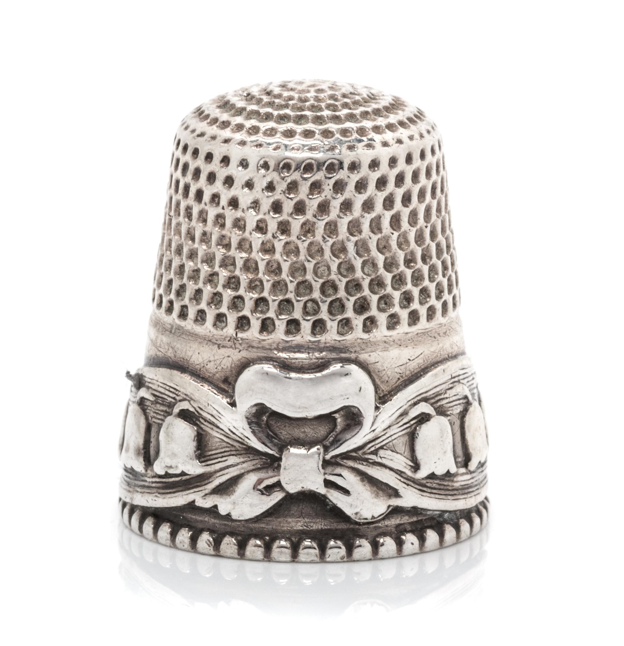 An American Silver Lily of the Valley Thimble, Stern Bros., Philadelphia, PA, the knurled top and body above a band worked to show ribb
