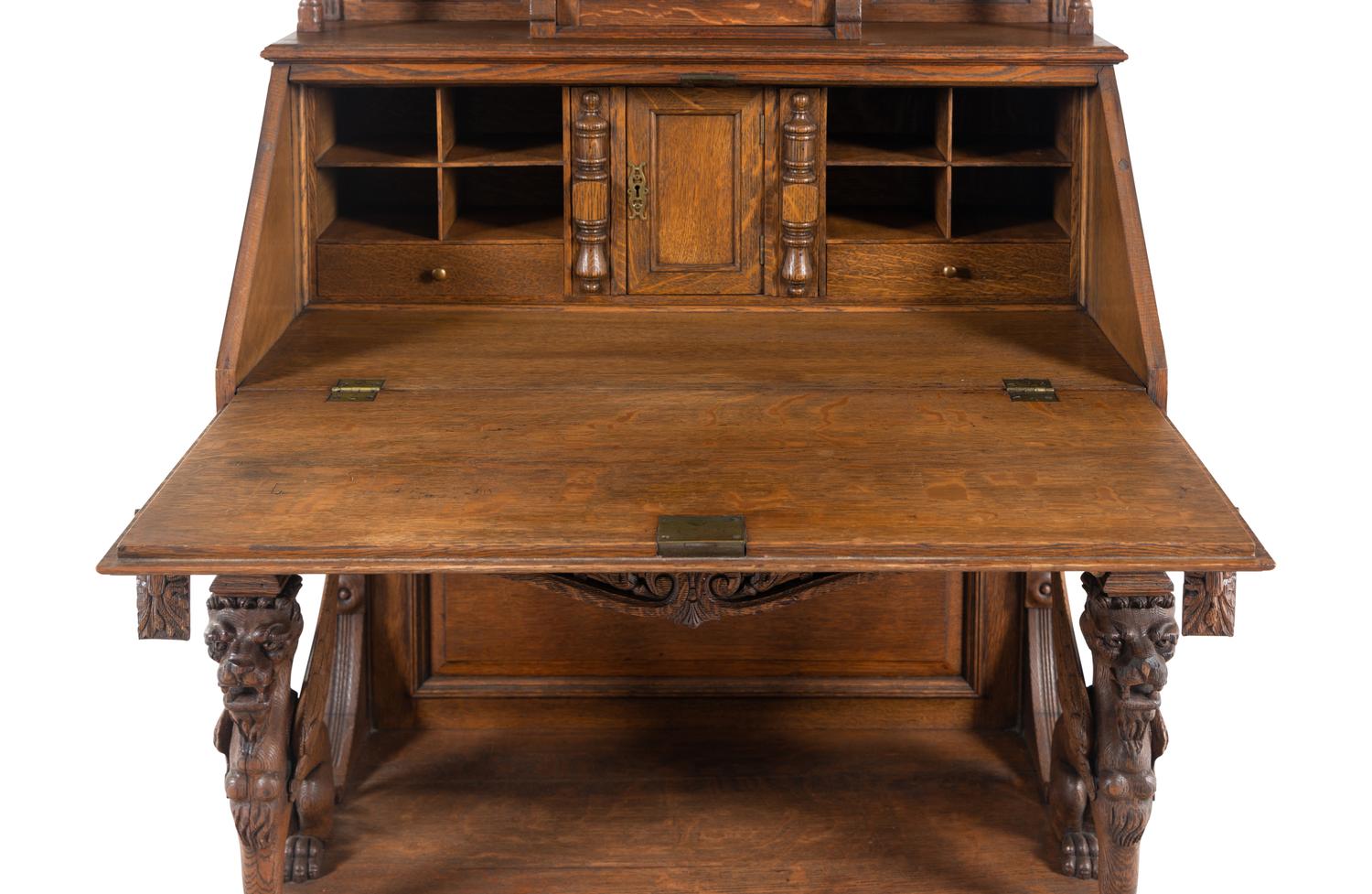 A Renaissance Revival Carved Oak Slant-Front Bureau