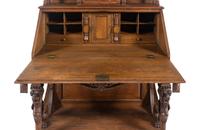 A Renaissance Revival Carved Oak Slant-Front Bureau
