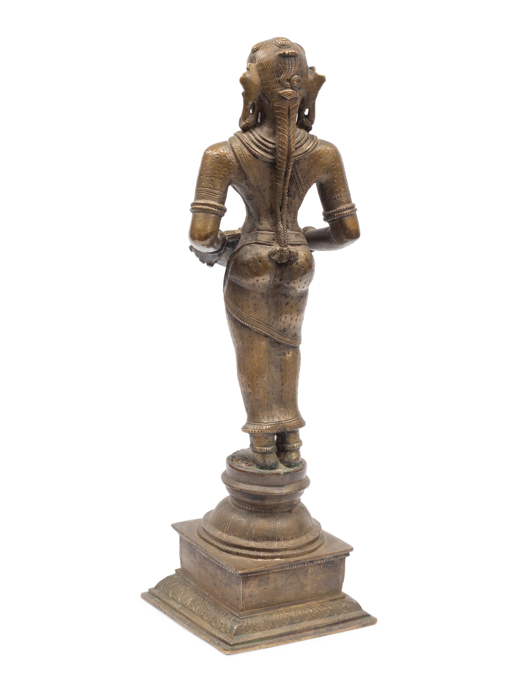An Indian Patinated Metal Figure of a Standing Deity