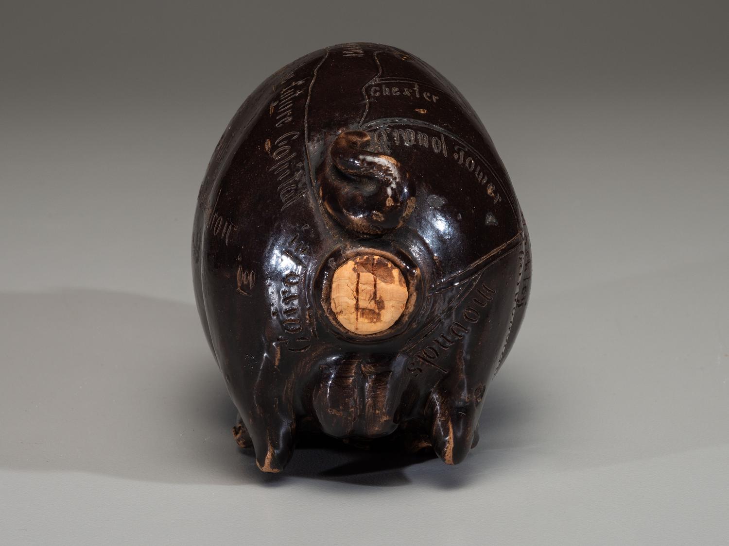 An Anna Pottery Incised and Brown Glazed Pig Flask