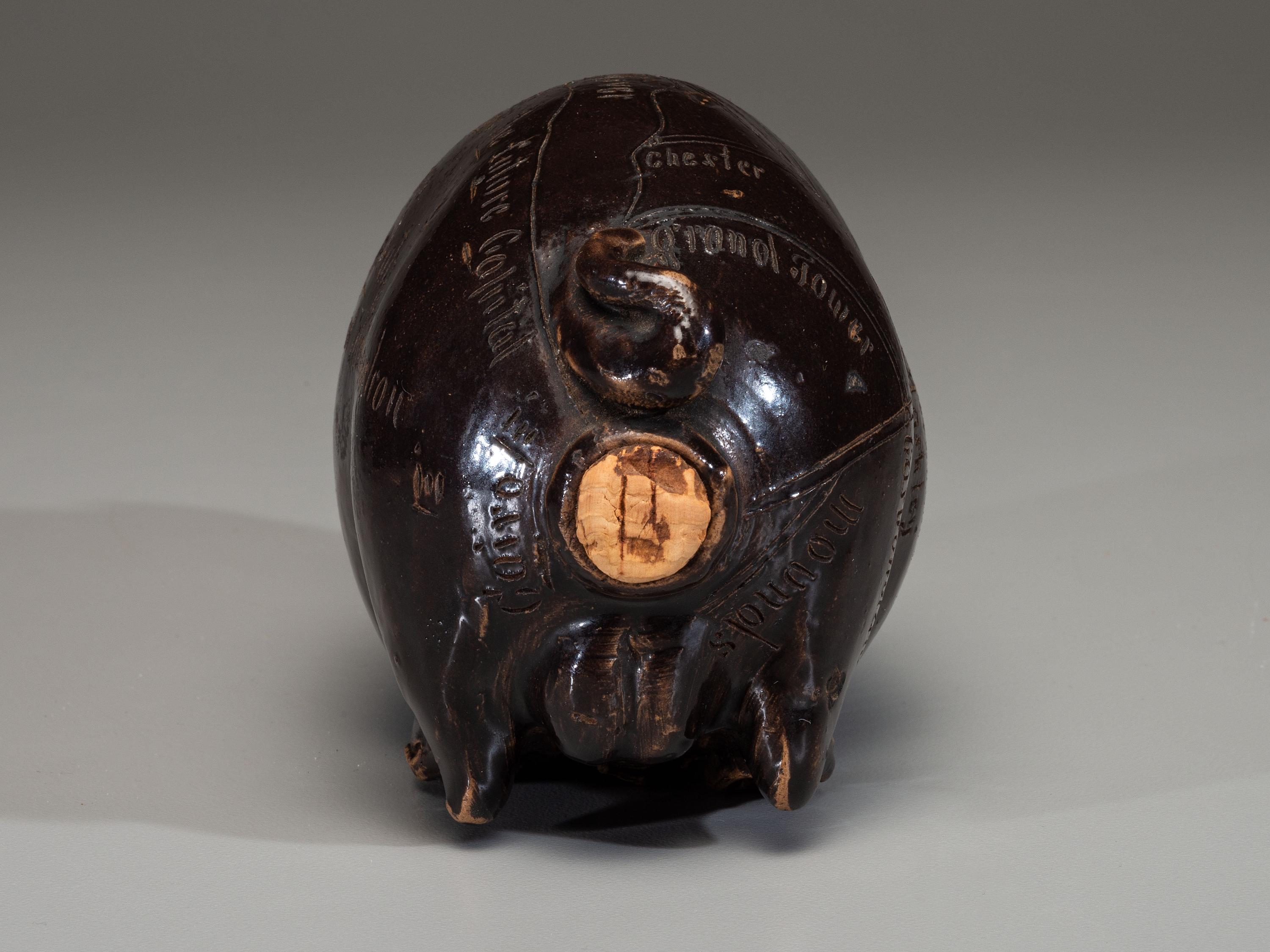 An Anna Pottery Incised and Brown Glazed Pig Flask