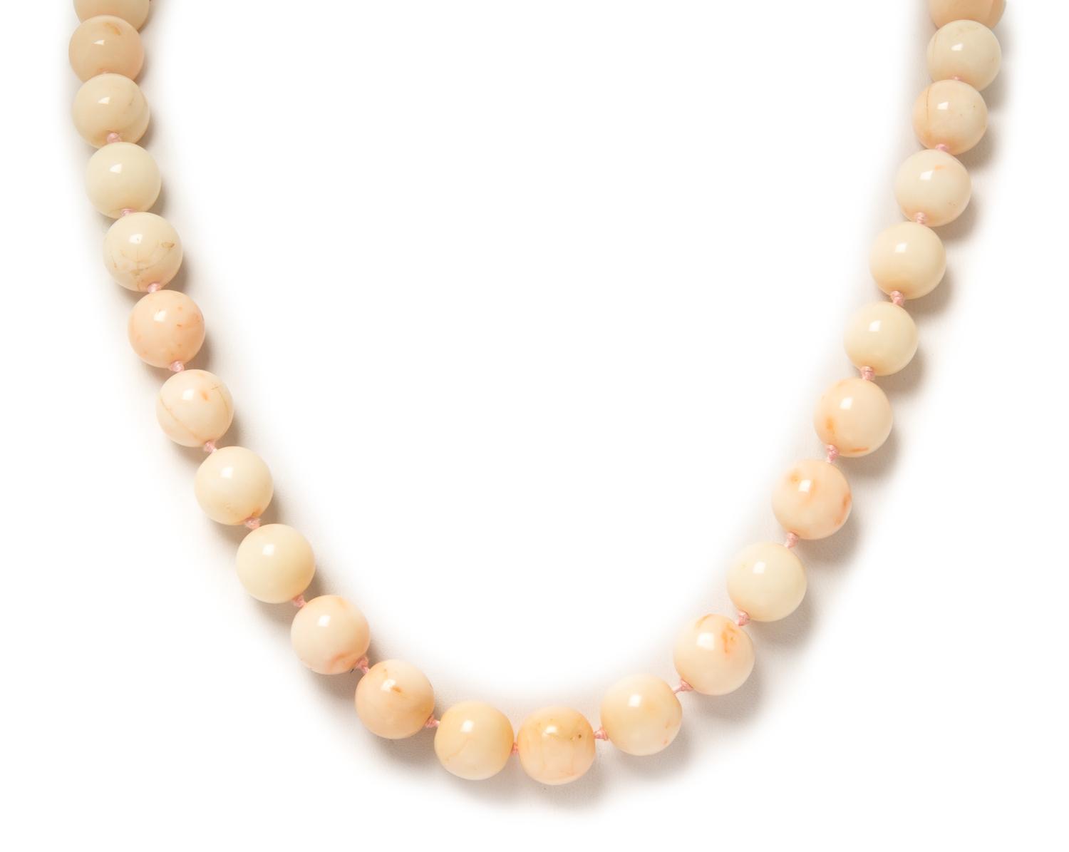 A 14 Karat Yellow Gold and Pink Coral Bead Necklace, 100.80 dwts.