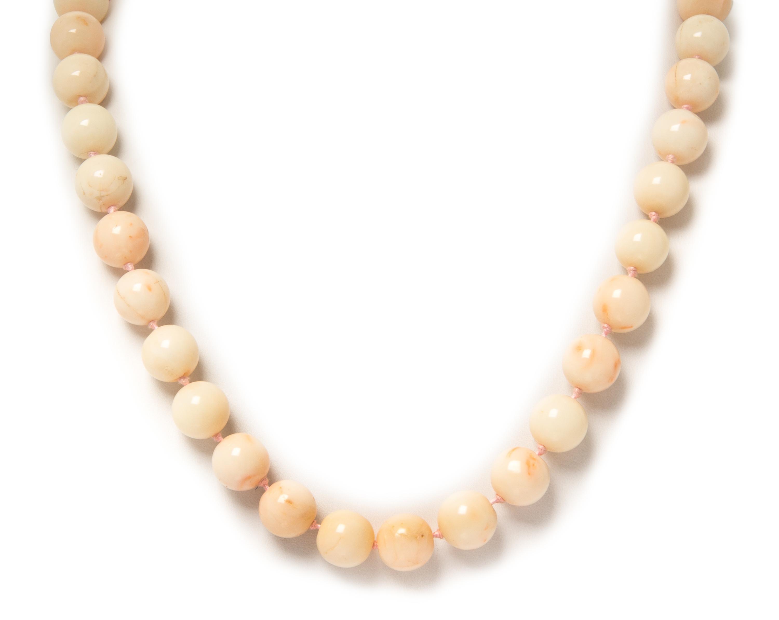 A 14 Karat Yellow Gold and Pink Coral Bead Necklace, 100.80 dwts.