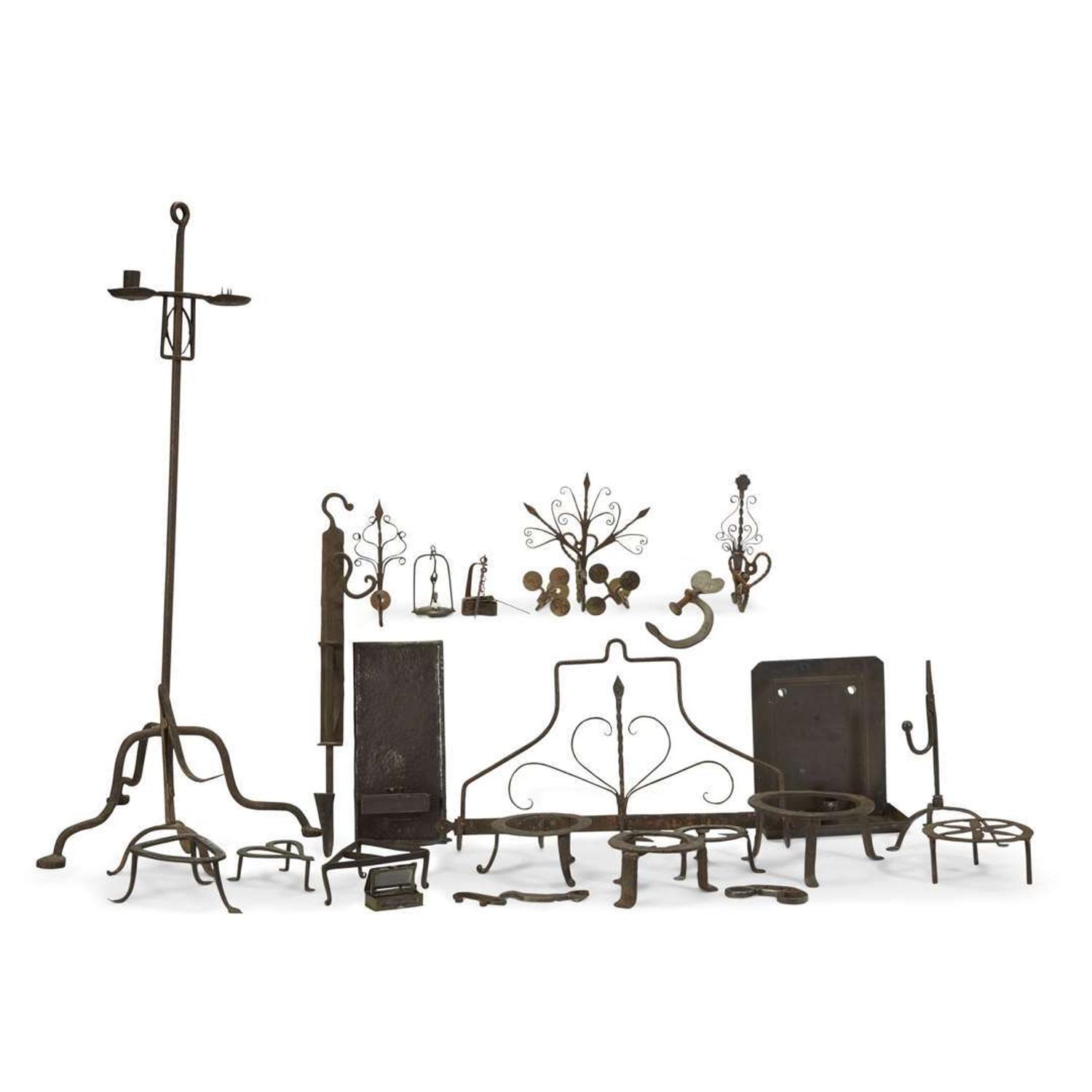 Large collection of twenty-seven wrought iron and metal fireplace and lighting implements 18th/19th century