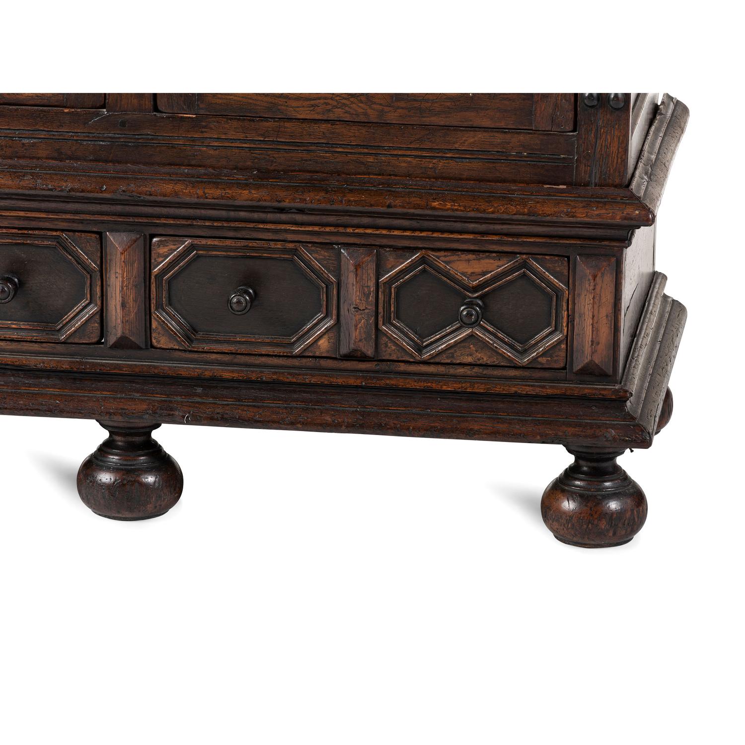 A Flemish Paneled and Molded Oak Chest of Drawers