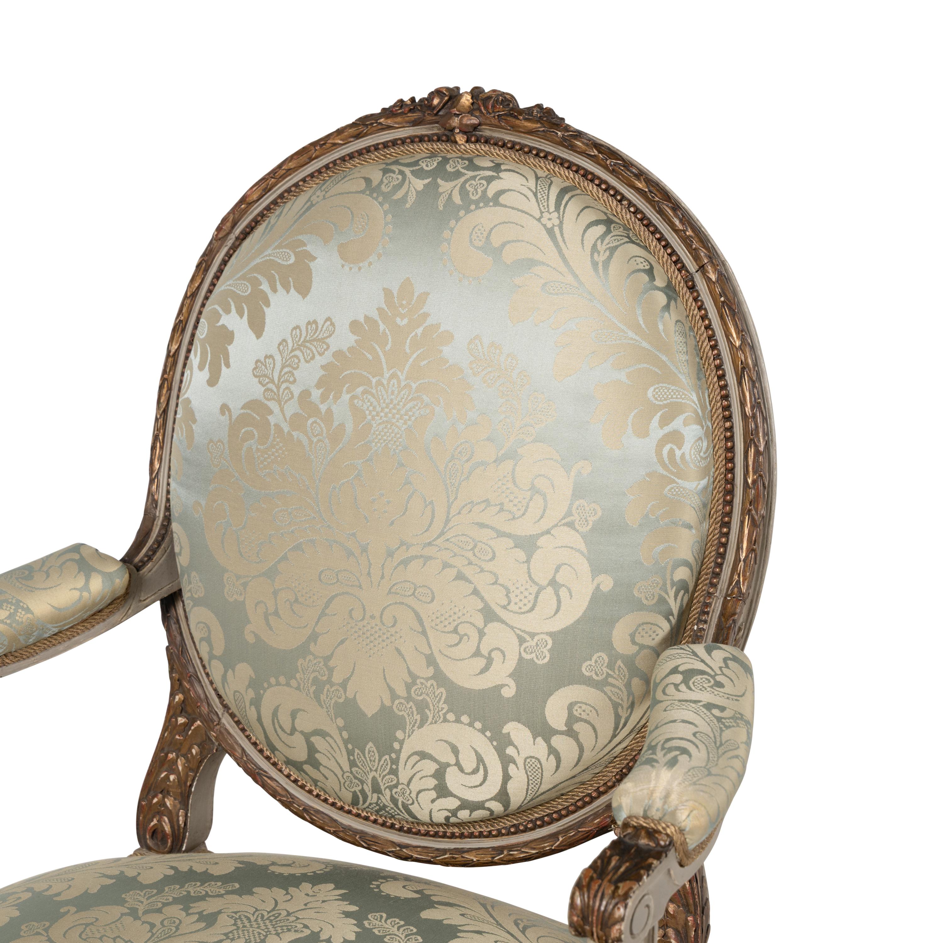 A Set Three of Louis XVI Style Grey-Painted and Parcel Gilt Fauteuils