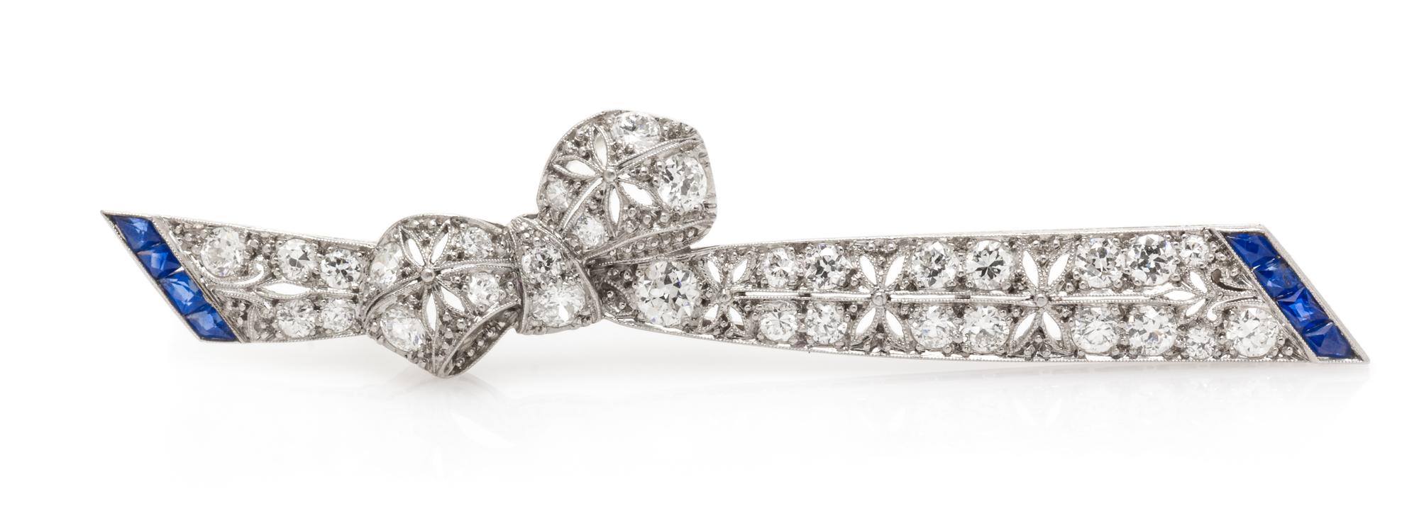 An Art Deco Platinum, Diamond and Sapphire Bow Bar Brooch, 5.80 dwts.