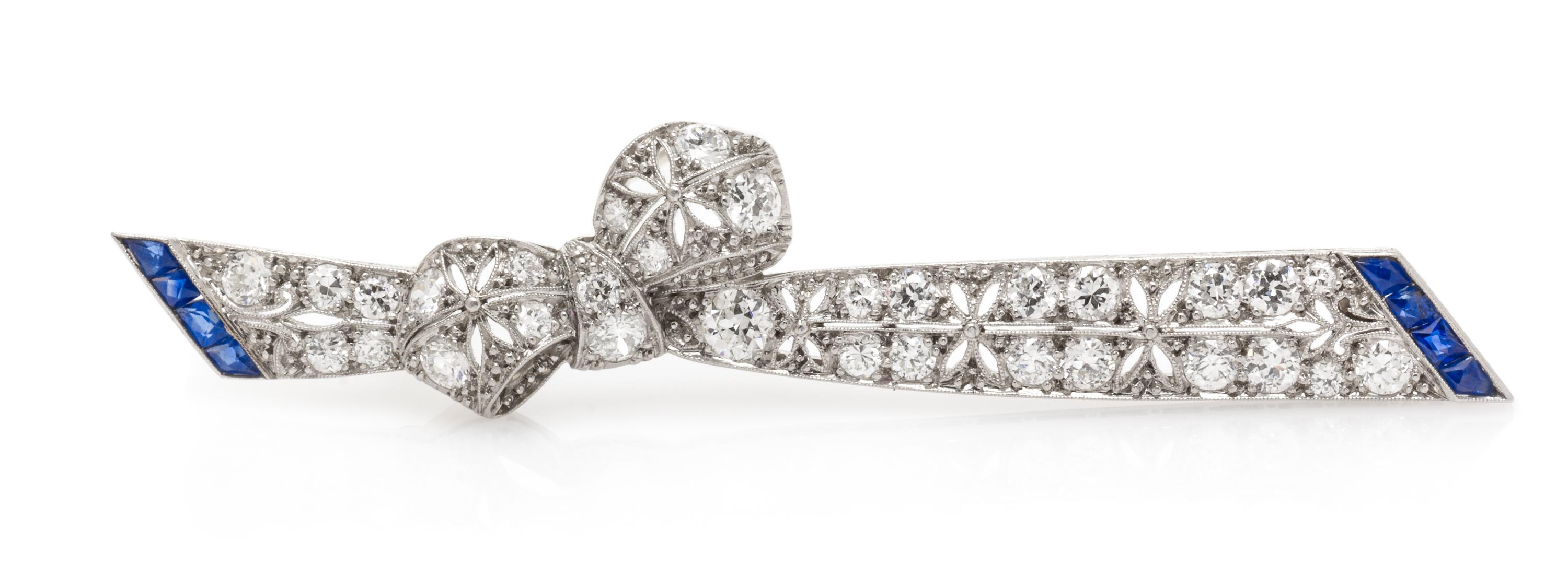An Art Deco Platinum, Diamond and Sapphire Bow Bar Brooch, 5.80 dwts.