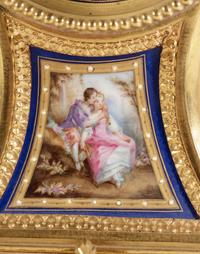 A Louis XVI Style Porcelain Inset Gilt Bronze Mantel Clock