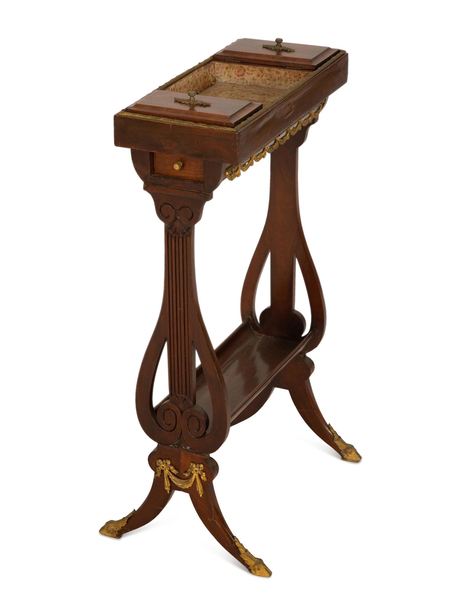 A French Empire Gilt Metal Mounted Mahogany Work Table