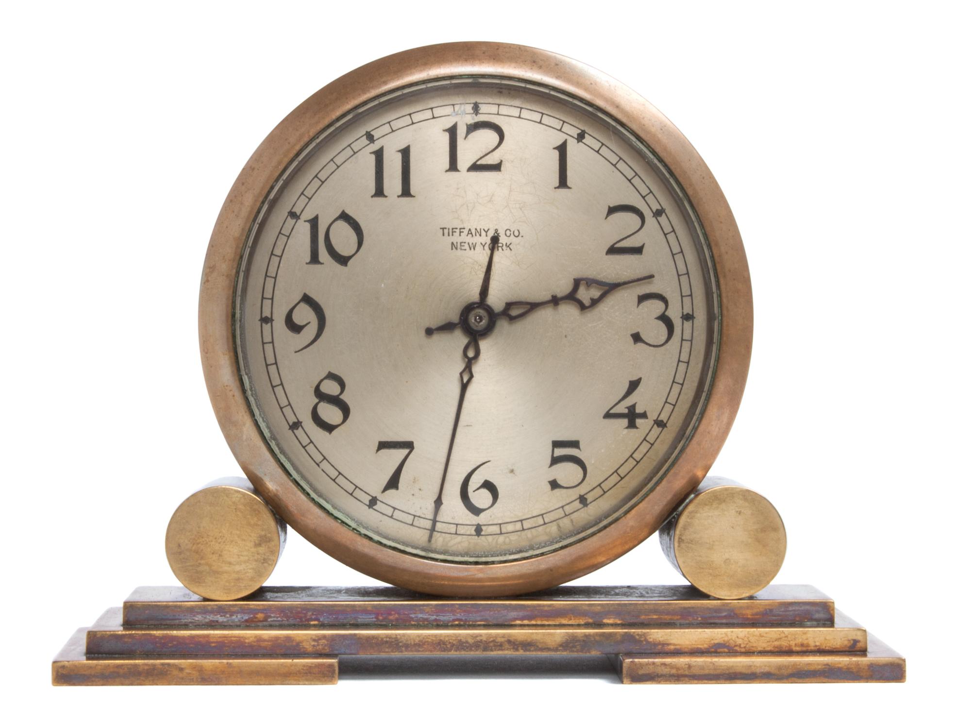 An Art Deco Brass Desk Clock Height 4 7/8 x width 6 3/8 x depth 2 1/4 inches. — TIFFANY & CO., NEW YORK